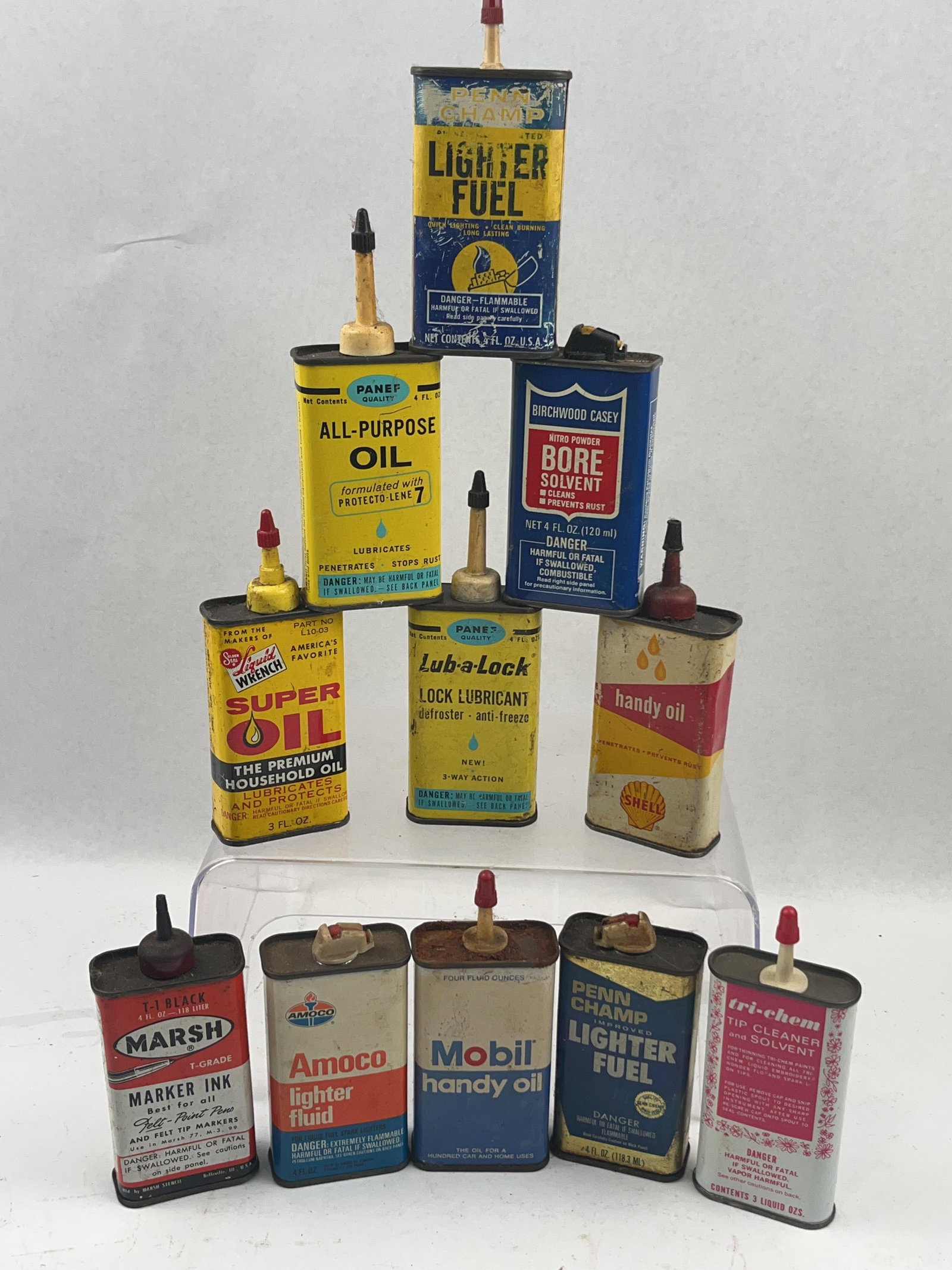 12 Vtg Advertising Tin Oil & Fuel Cans: A collection of twelve mid-20th-century lithographed tin containers for various household and automotive fluids, including lubricants, lighter fuels, solvents, and ink. The lot features a variety of