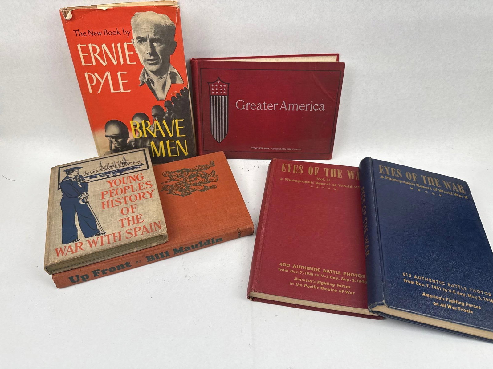 A Collection of Historical Military Books: A collection of historical military volumes focusing on the Spanish-American War and World War II. The group features several prominent titles of 20th-century wartime journalism and photography.