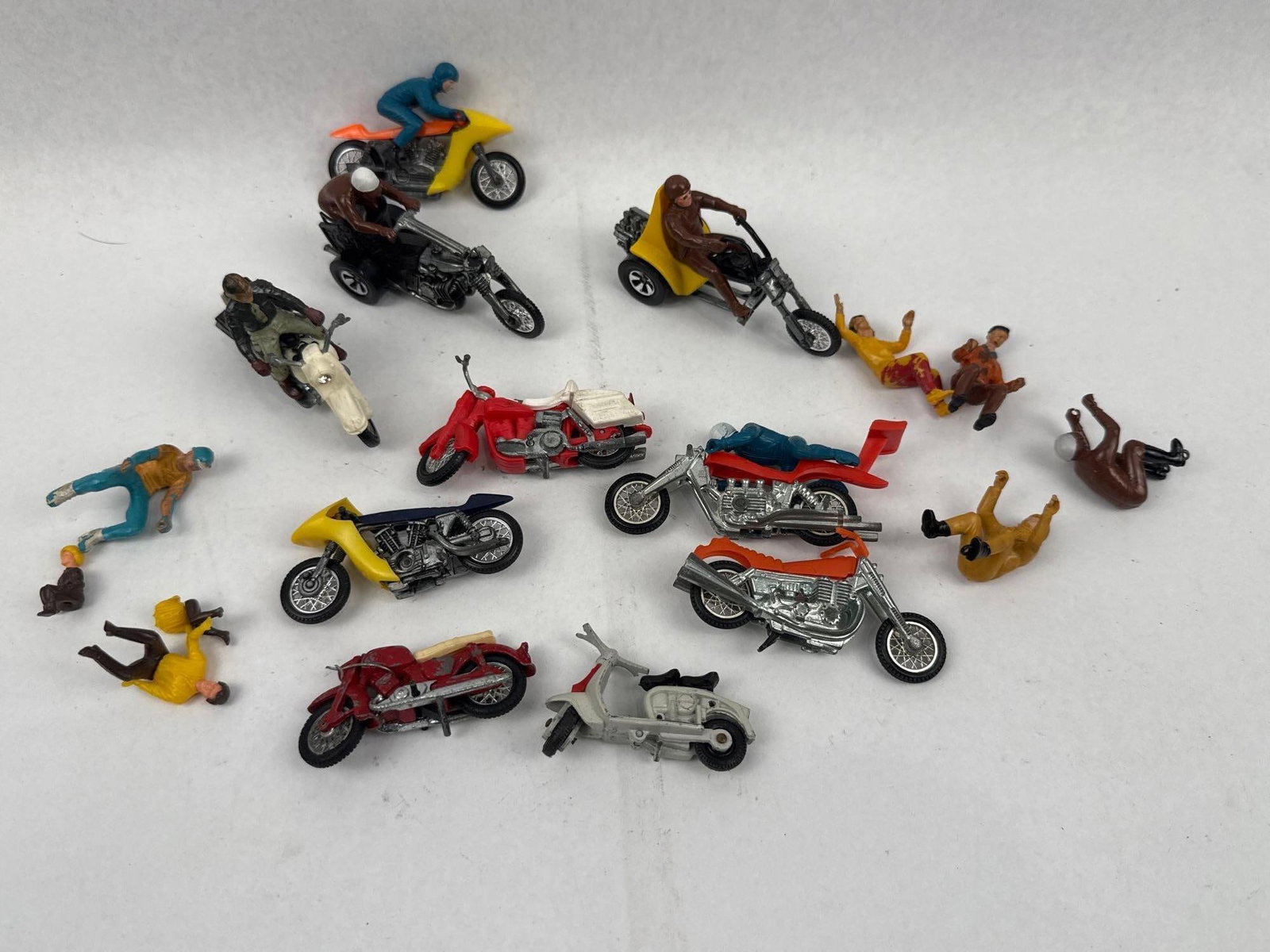 Die-Cast & Plastic Toys & Figures: An assortment of vintage die-cast metal and plastic toy motorcycles, trikes, and figures. The group features various motorcycle styles, including sport bikes with partial fairings, choppers with exten