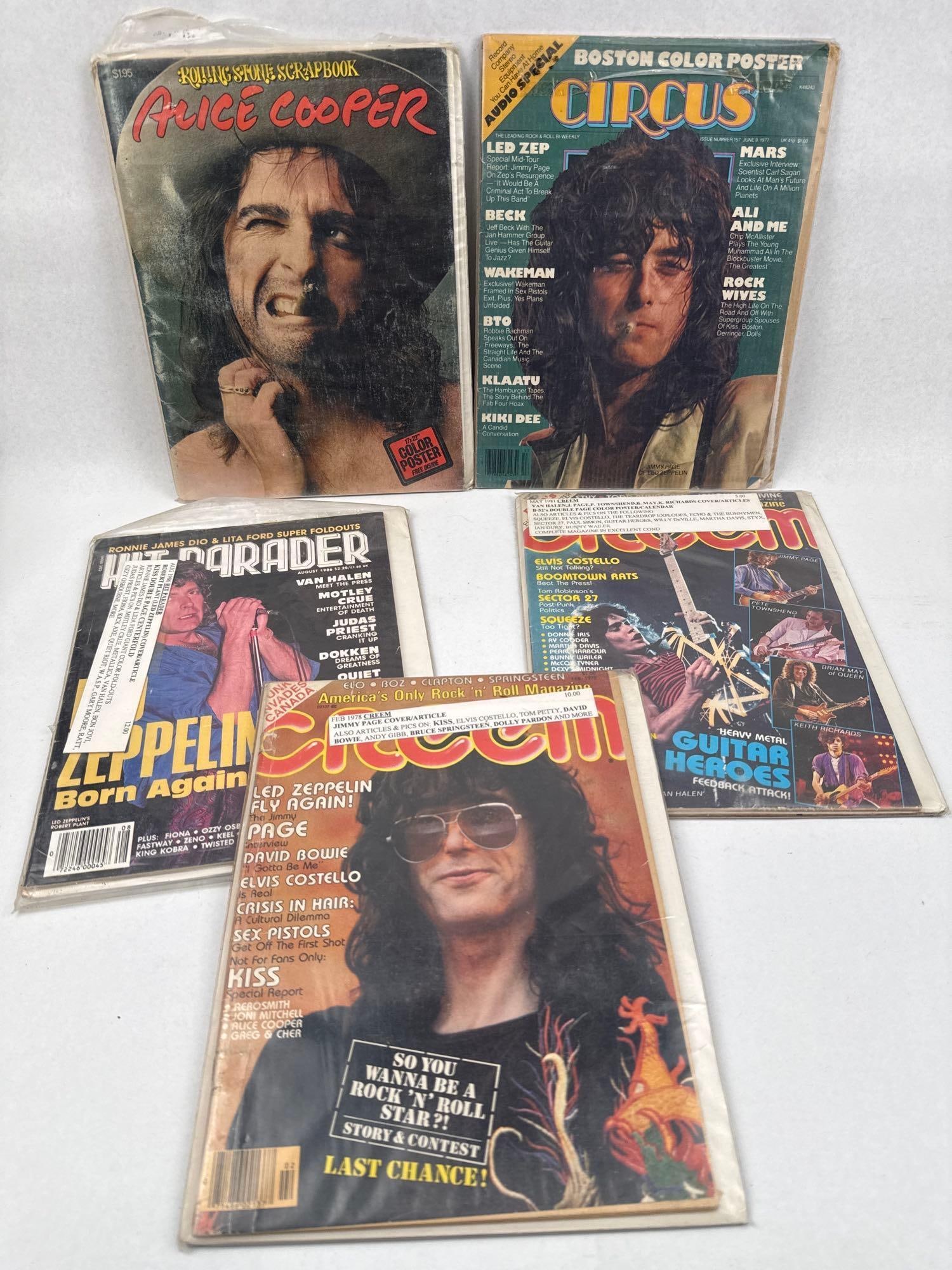 ags: Creem & Circus". No, the prompt: A collection of vintage rock and roll music magazines and ephemera dating from 1977 to 1986. The assortment includes issues of Creem, Circus, and Hit Parader, alongside a Rolling Stone Scrapbook dedic