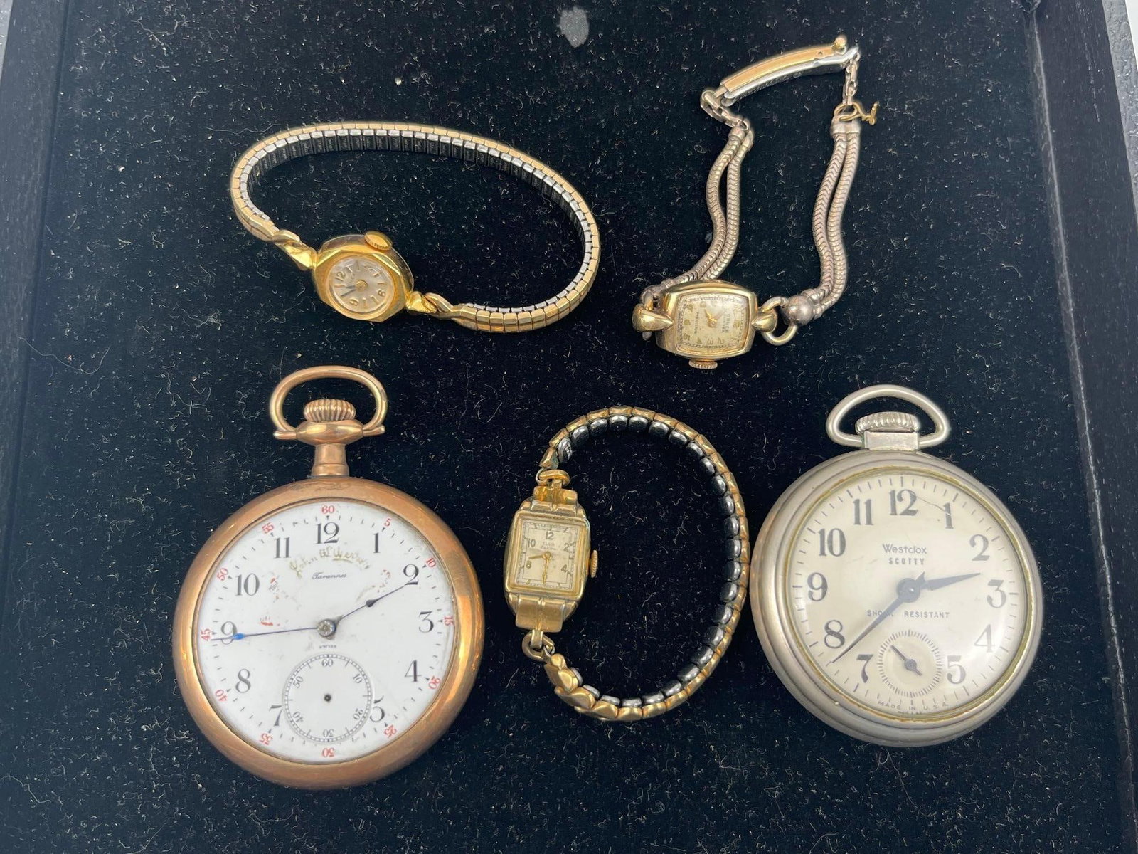 Tavannes, Gruen, Elgin & Timex Watches: A group of vintage manual wind and mechanical timepieces, comprising open-face pocket watches and ladies' wristwatches. One open-face pocket watch features a white enamel dial printed with John W.