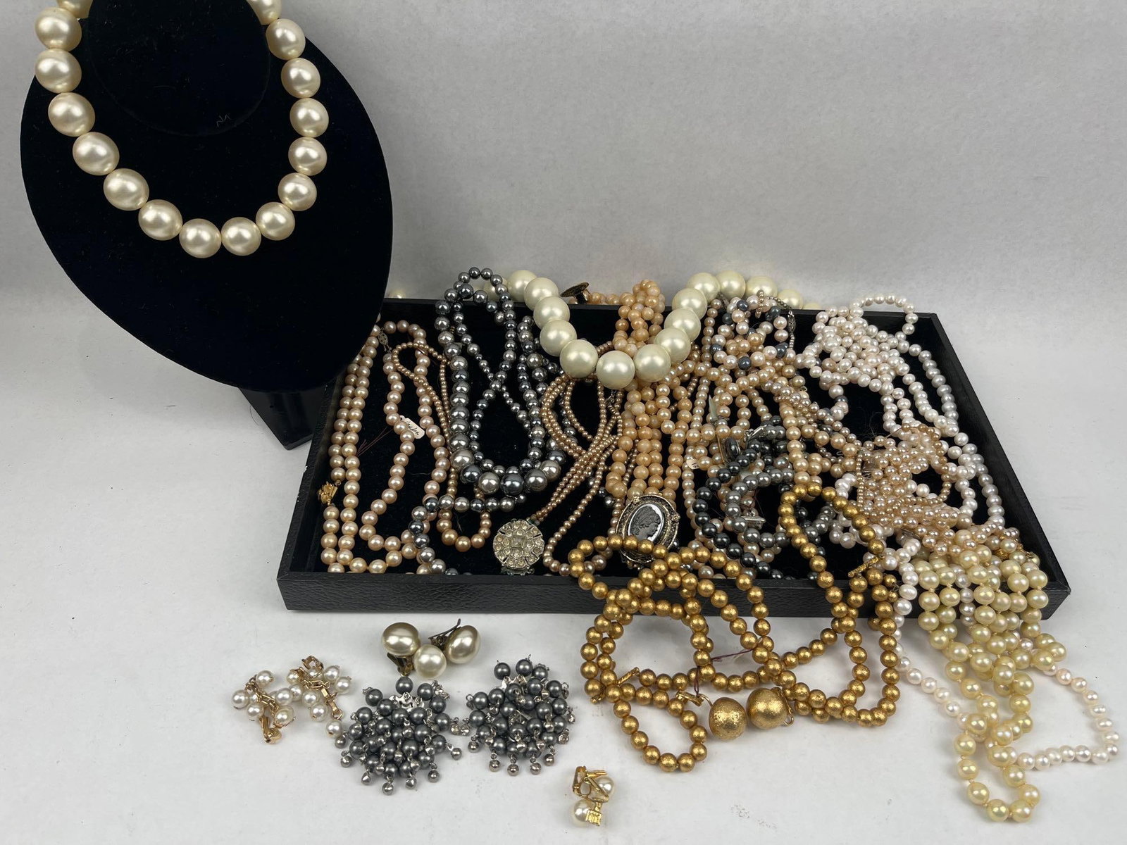Faux Pearl Jewelry Collection: An assortment of vintage costume jewelry primarily composed of faux pearls and base metal findings. The collection features a variety of necklaces including single and multi-strand designs in