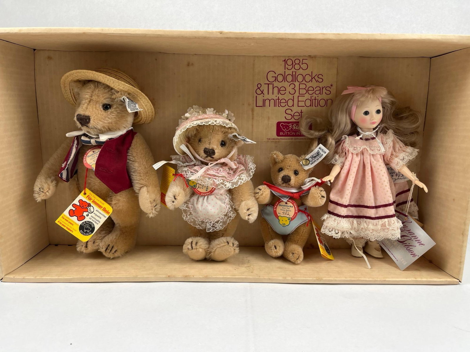 Gibson & Steiff Goldilocks & Bears Set: A 1985 limited edition collaborative set produced by Suzanne Gibson Dolls from Reeves International and Margarete Steiff GmbH. The set includes a Suzanne Gibson Goldilocks doll and three jointed