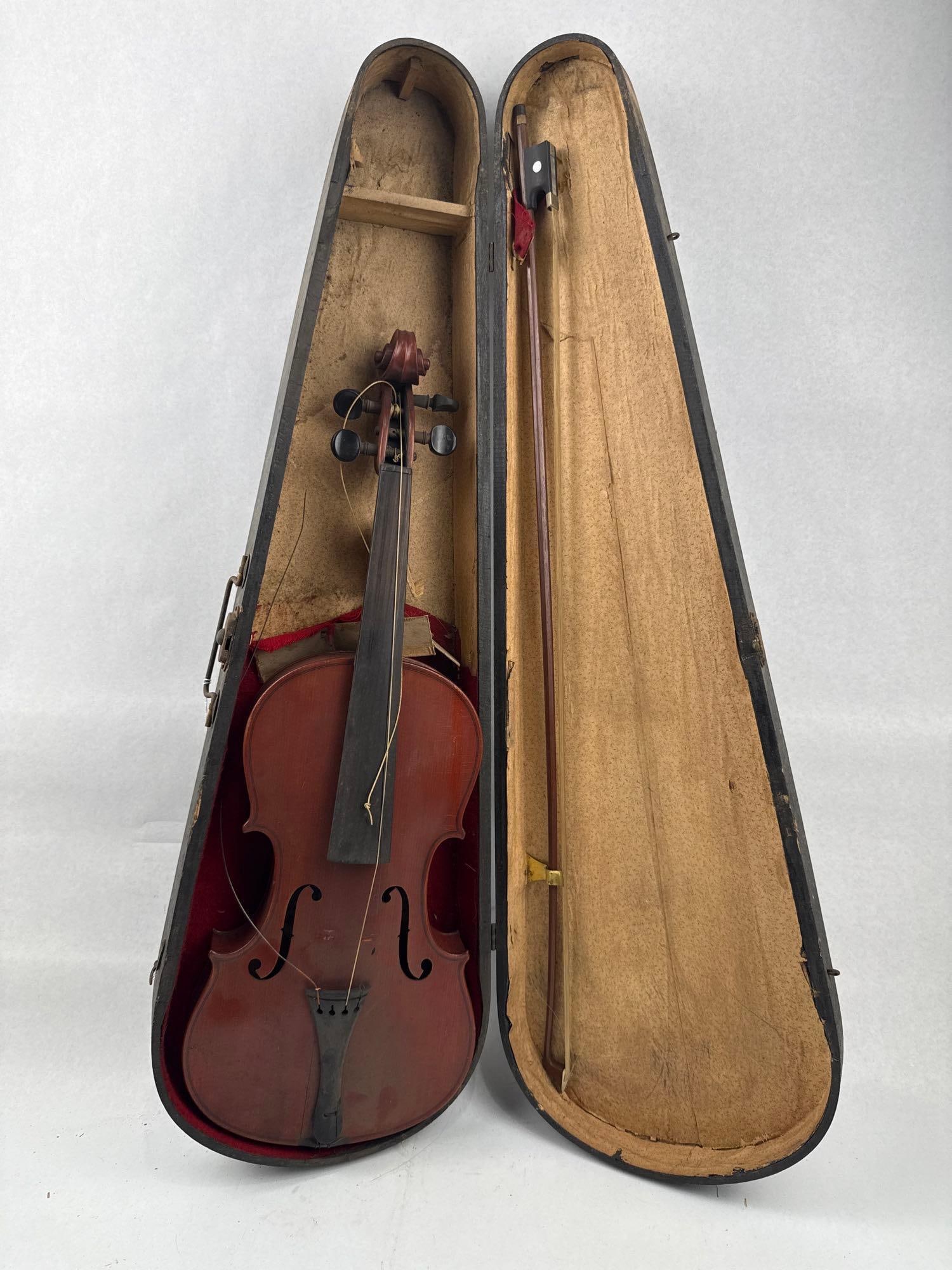 Imperial Trade Mark Violin, Bow & Case: This antique violin is constructed with a two-piece maple back and finished in a reddish-brown varnish. The instrument features a carved scroll and dark-stained pegs and fingerboard. An interior oval