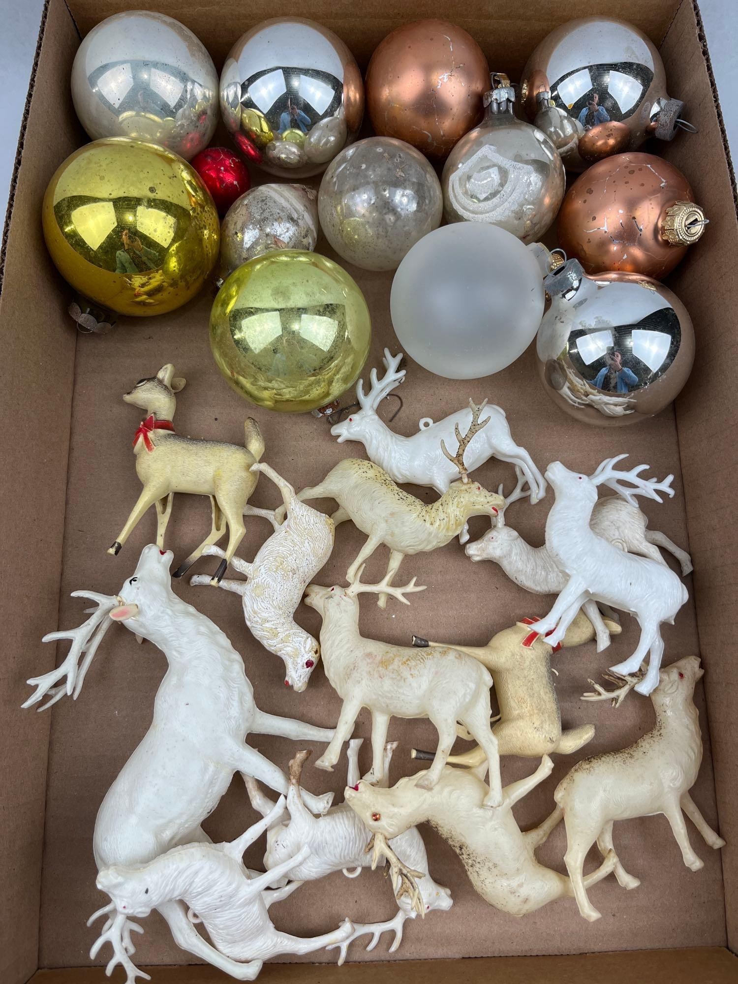 Glass Ornaments & Plastic Reindeer: An assortment of vintage mid-century holiday decorations comprising multiple glass ornaments and molded plastic reindeer figurines. The reindeer are rendered in assorted poses, including standing and
