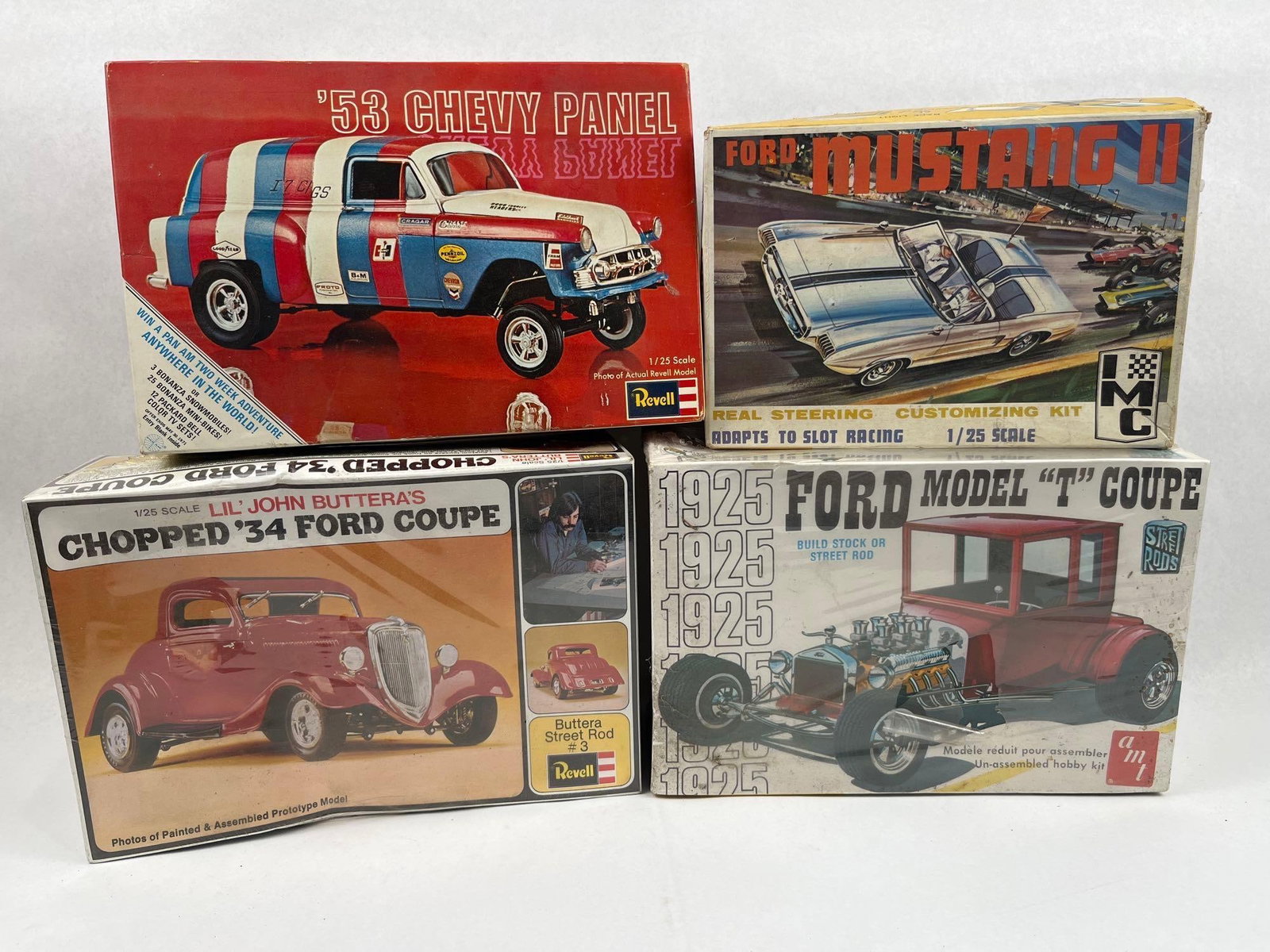 Revell, IMC & AMT 1/25 Model Car Kits: A group of vintage 1/25 scale plastic model kits of mid-century American automotive subjects, including custom street rods and commercial vehicles. The collection features a Revell 53 Chevy Panel