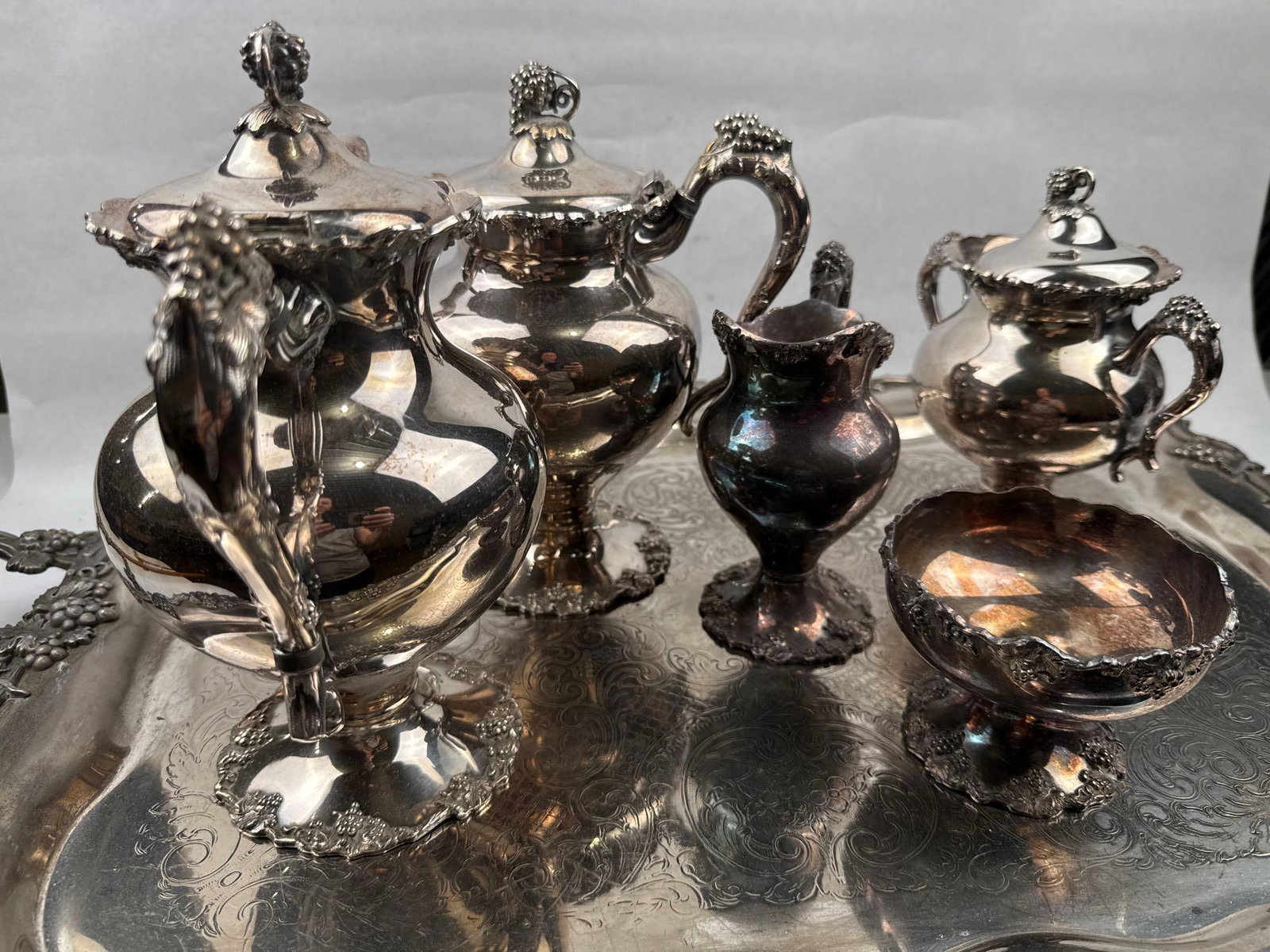 International Silver Service & Birm: A silver-plated tea and coffee service comprising a tall lidded coffee pot, a teapot, a double-handled lidded sugar bowl, a creamer, an open waste bowl, and a large presentation tray. The holloware