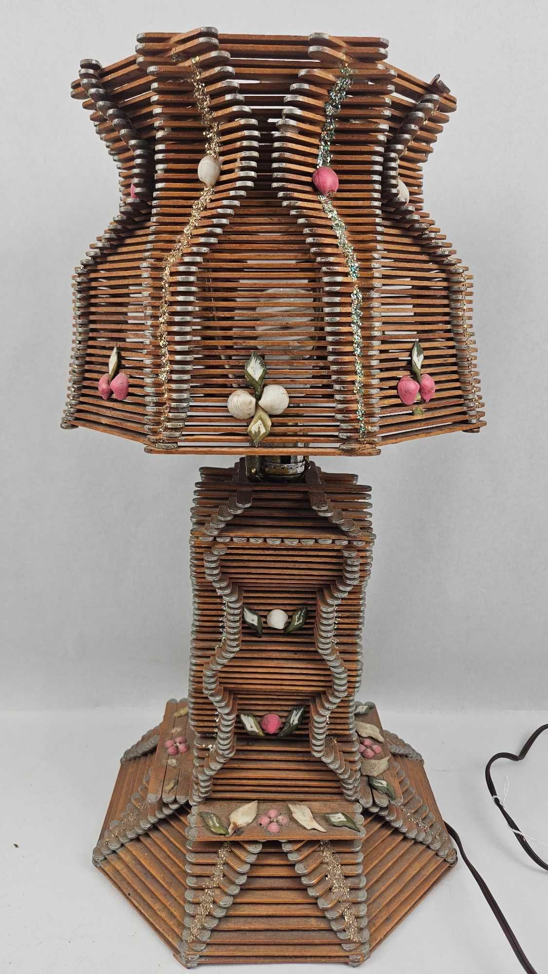 Tramp Art Popsicle Stick Lamp w/ Shells: An American folk art table lamp in the tramp art tradition, constructed from multiple layers of wooden craft sticks. The piece comprises an octagonal, flared shade and a matching tiered base with a