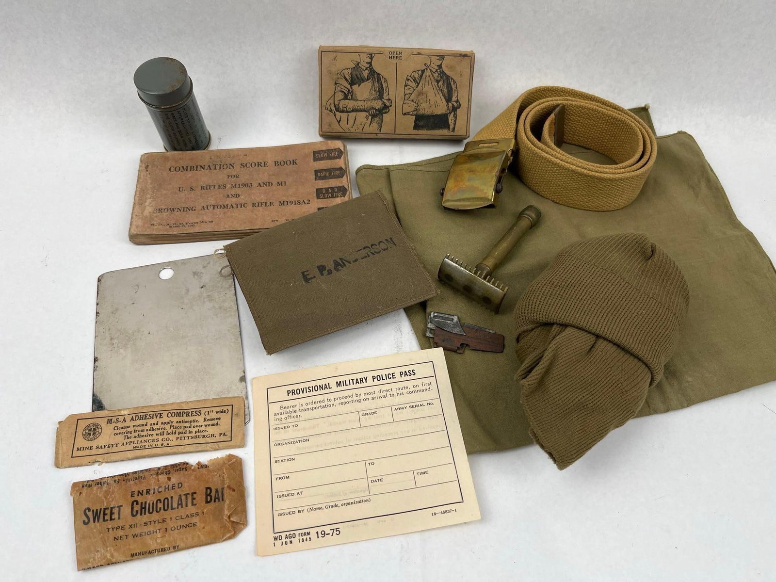 Assortment of US Military Personal Effects, Documents, and Field Gear: An assortment of mid-20th-century US military personal effects, documents, and field gear. The collection includes: - A "COMBINATION SCORE BOOK FOR U. S. RIFLES M1903 AND M1 AND BROWNING AUTOMATIC