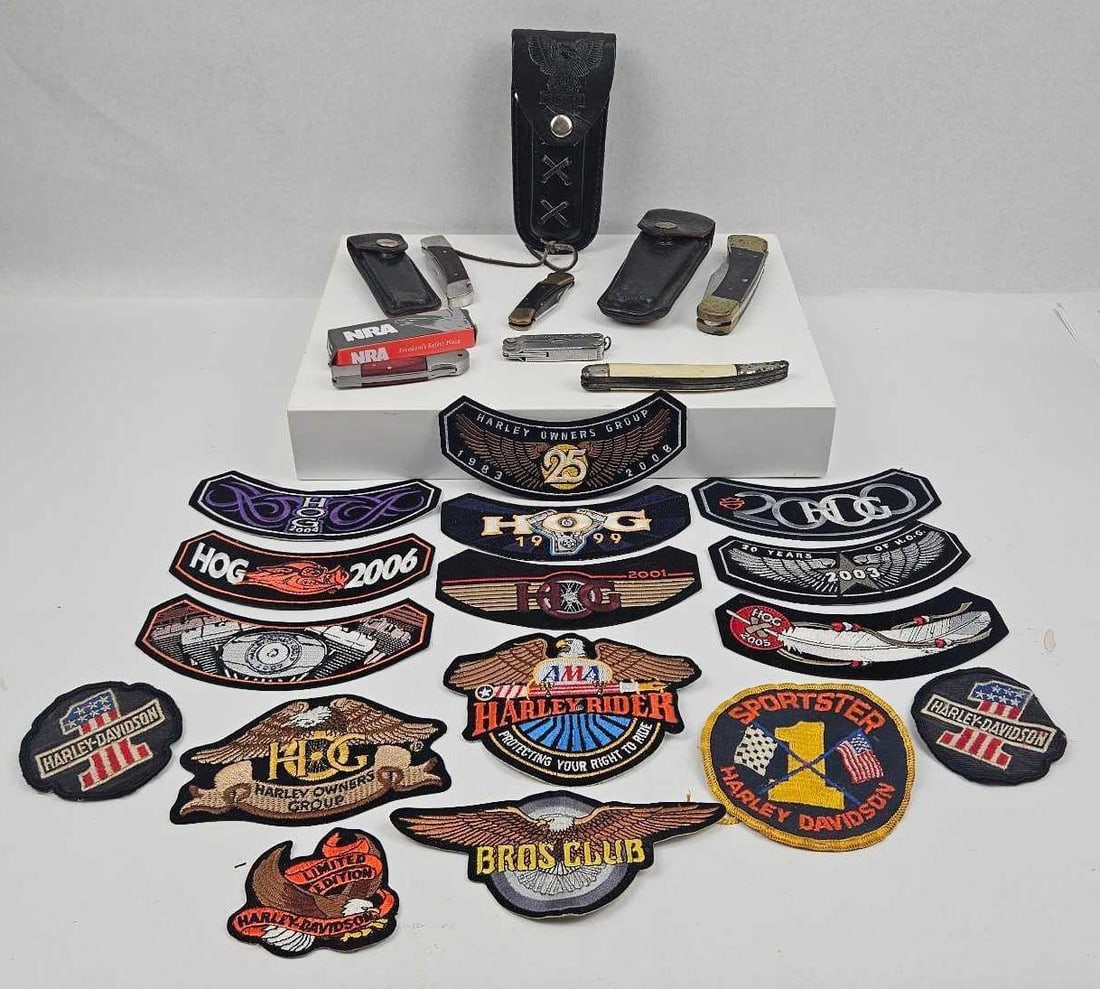 Harley-Davidson & HOG Knives & Tools: An assortment of motorcycle-themed memorabilia and utility tools, primarily associated with the Harley Owners Group (H.O.G.). The lot features multiple embroidered patches, including a wide rocker