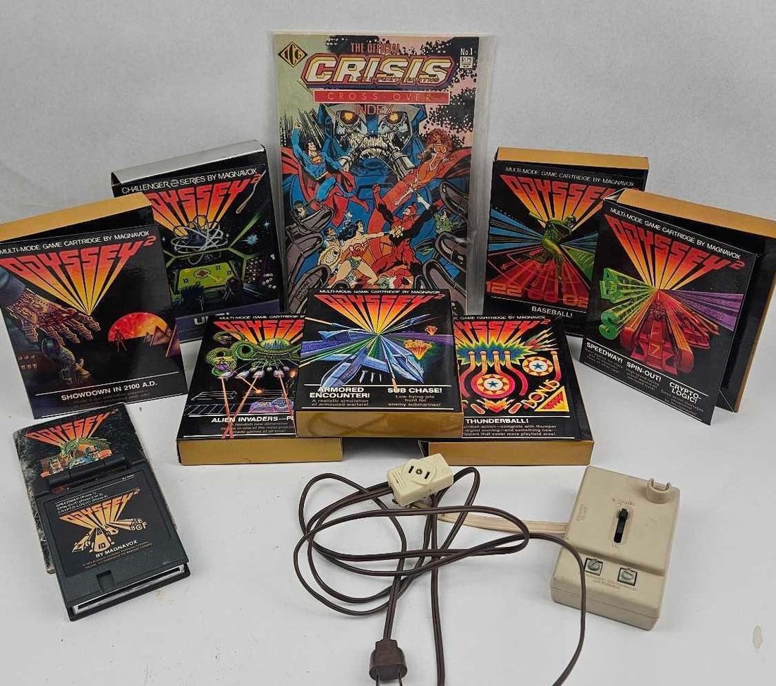 Magnavox Odyssey 2 Game & Accessory Set: A group of vintage home video game software and hardware components designed for the Magnavox Odyssey 2 console, alongside a related comic book index. The software consists of multiple boxed game