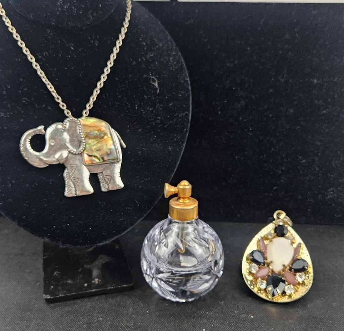 Abalone Necklace, Scent Bottle, Pendant: A collection of three decorative items and pieces of jewelry. The first item is a silver-tone necklace featuring a large elephant-shaped pendant. The elephant is depicted with a raised trunk and is