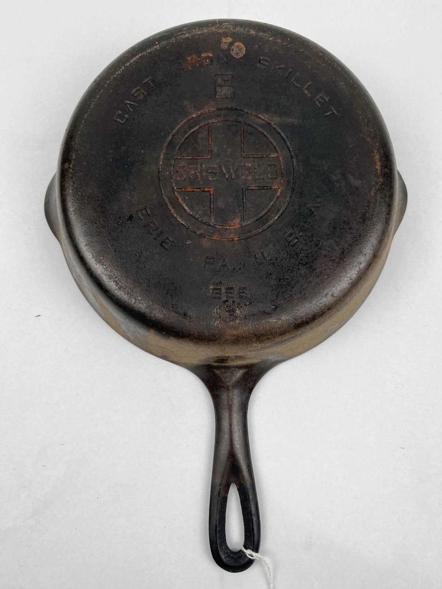 Griswold No. 6 Large Block Logo Skillet: A Pennsylvania cast iron skillet featuring two pouring spouts and a smooth, flat base. The underside is impressed with the arched words CAST IRON SKILLET above a boxed numeral 6. A central