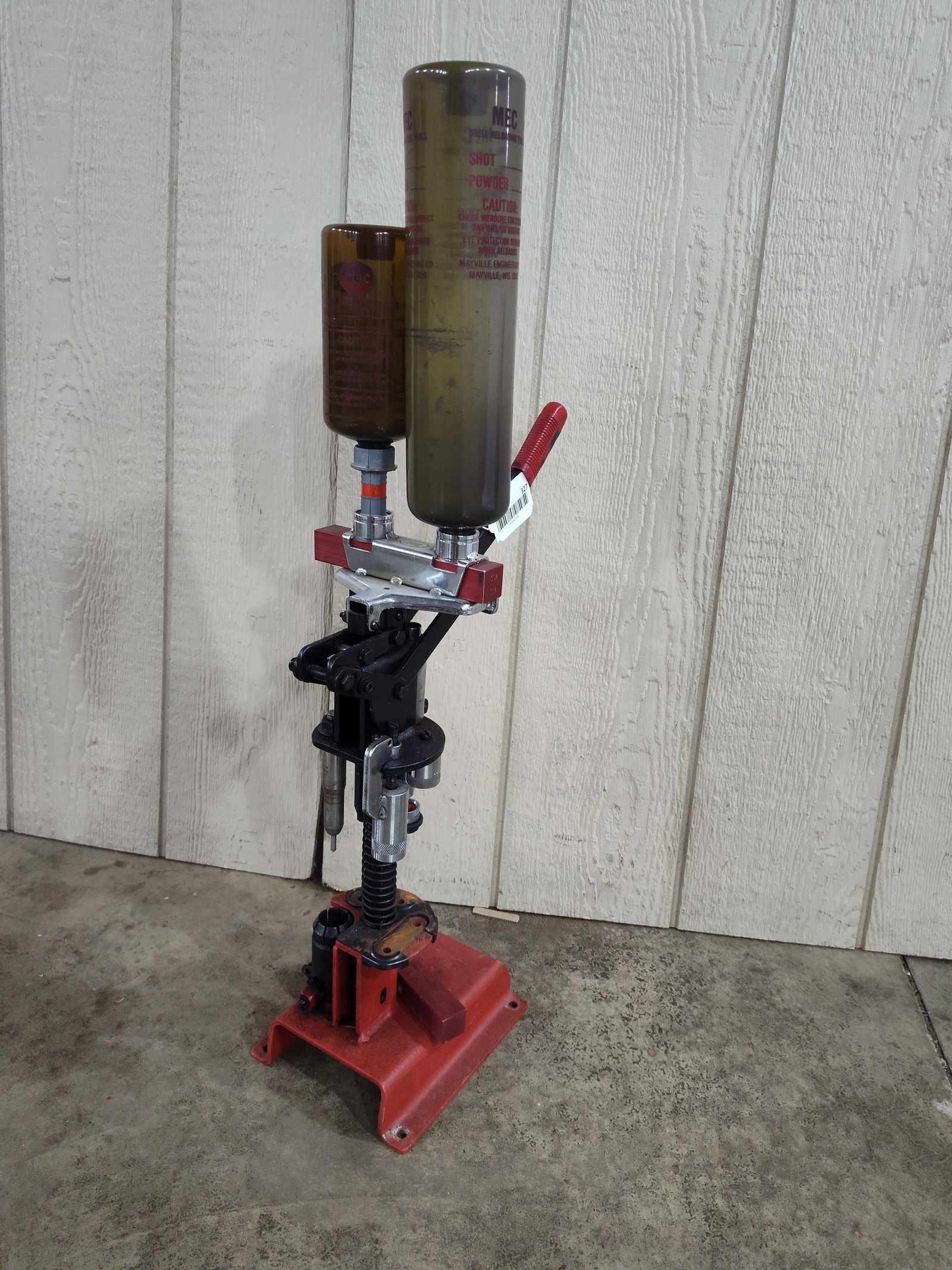 MEC Sizemaster S1177 Reloading Press: A MEC Sizemaster model S1177 shotshell reloading press, manufactured by Mayville Engineering Co. The press features a cast and sheet metal frame with a red and black painted finish. It is equipped
