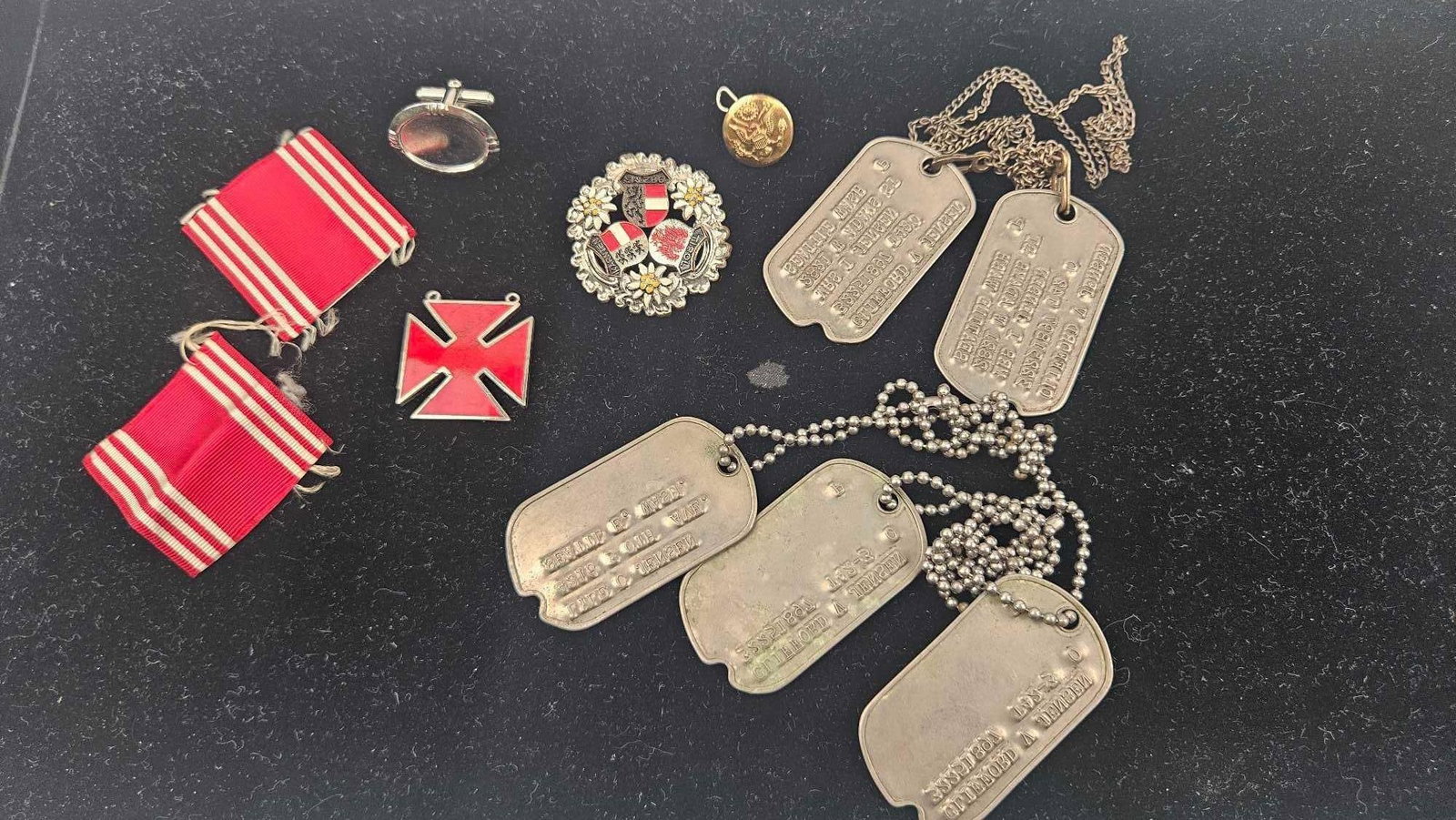 WWII US Army ID Tags & Ephemera: A group of mid-20th-century personal military and souvenir items relating to service in the U.S. Army. The collection features multiple debossed metal identity tags. One pair is inscribed with the