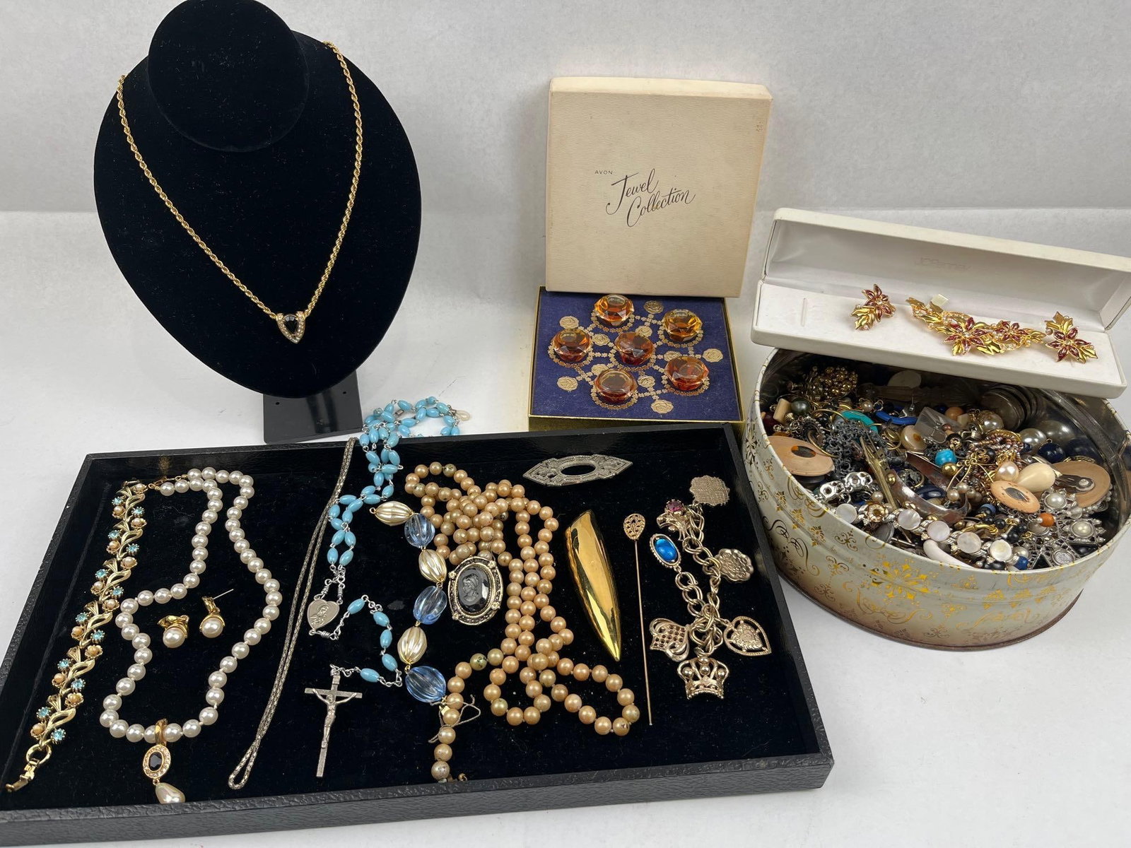 Costume Jewelry Collection: This assortment comprises a large variety of jewelry pieces and components in various materials including metal, glass, plastic, wood, and faux pearls. The collection includes several necklaces, such