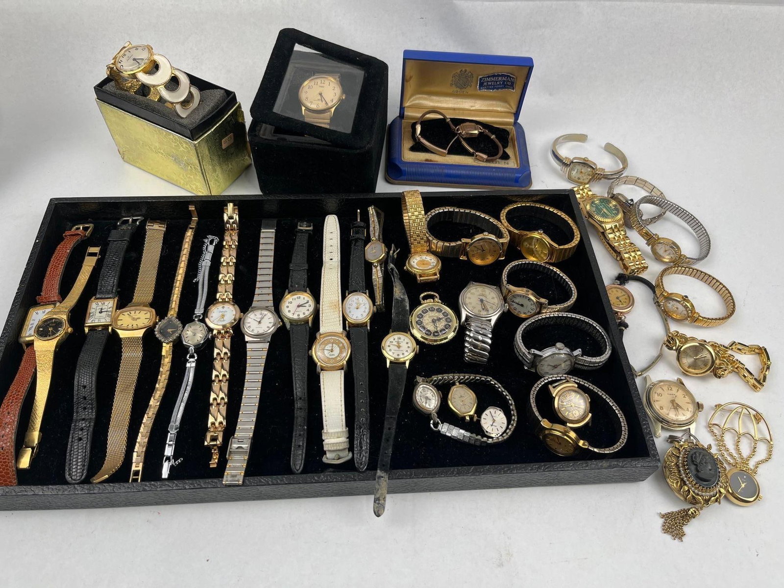 Gruen & Timex Watches & Accessories: An assortment of vintage and modern ladies' timepieces and jewelry accessories. The collection includes a blue presentation case with an adhesive silver-colored label reading ZIMMERMAN JEWELRY CO.