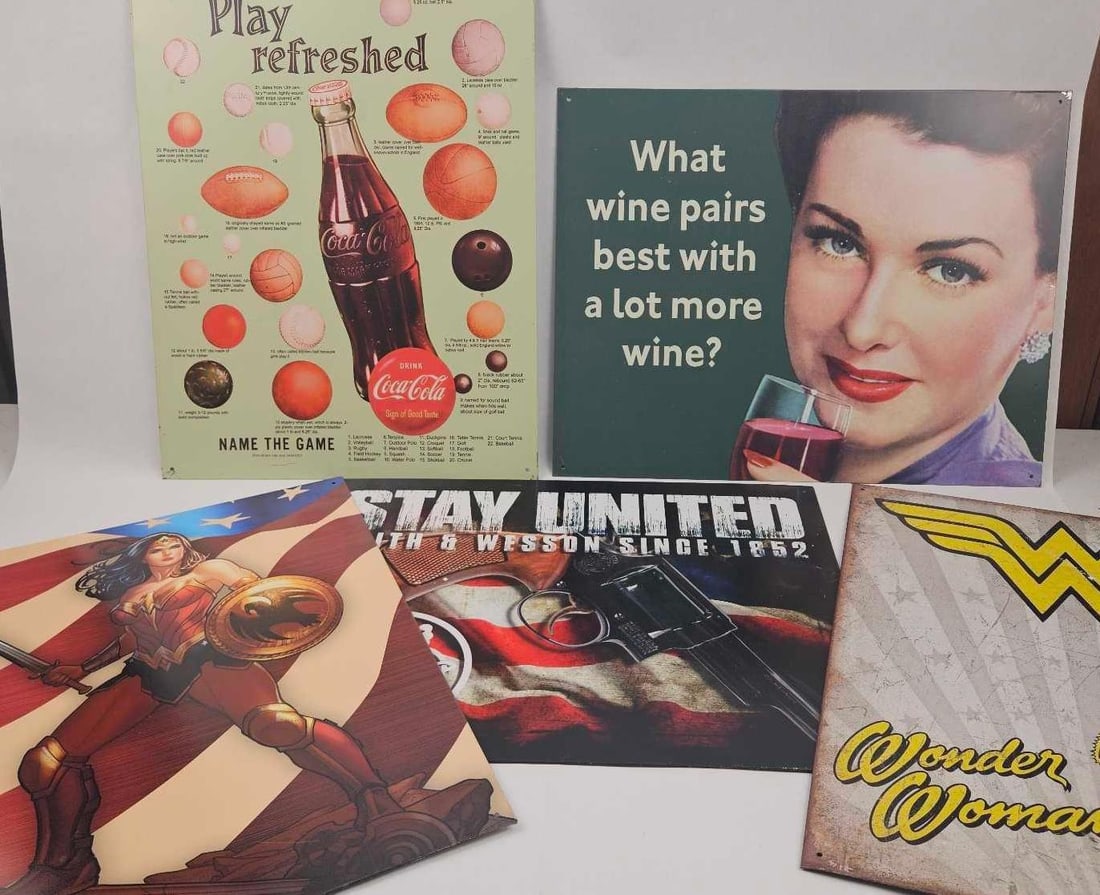 Desperate Enterprises Tin Ad Signs: A collection of lithographed tin wall signs featuring various advertising, pop culture, and Americana themes. The group includes a Coca-Cola themed sports trivia sign titled Play refreshed and NAME TH
