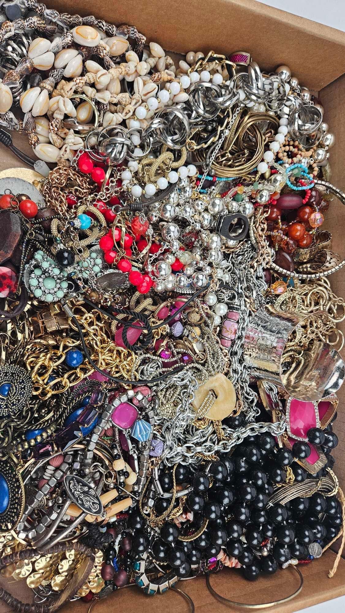 Assorted & Modern Costume Jewelry: An assortment of assorted costume jewelry including necklaces, bracelets, earrings, and rings. The collection features a variety of materials such as gold-tone and silver-tone base metals, polished