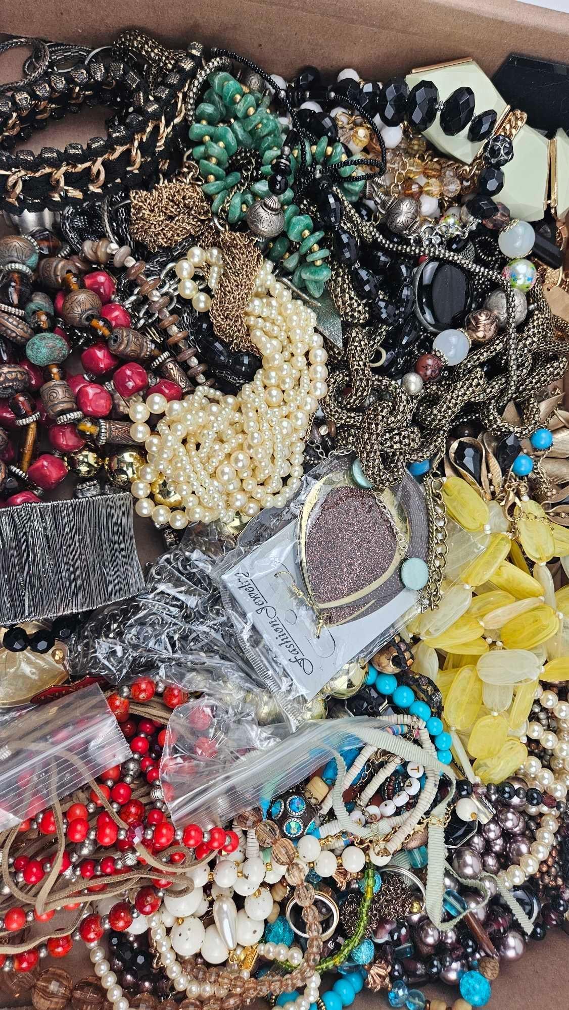 & Costume Jewelry Assortment: An assortment of costume jewelry comprising necklaces, bracelets, and earrings in various styles and materials. The collection features numerous beaded strands including faux pearls, faceted glass,