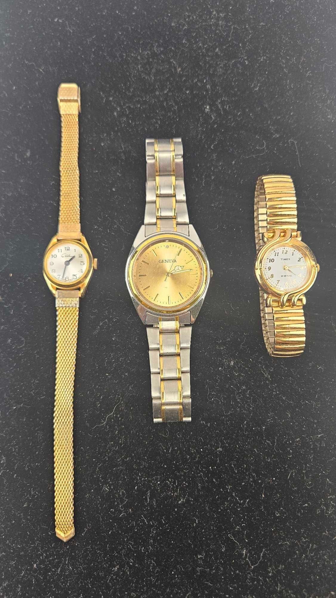 Timex, Chateau & Geneva Ladies' Watches: A trio of ladies' wristwatches in varying styles and finishes. The first timepiece features a gold-tone oval case with a white dial showing black Arabic numerals and black hands. A printed script