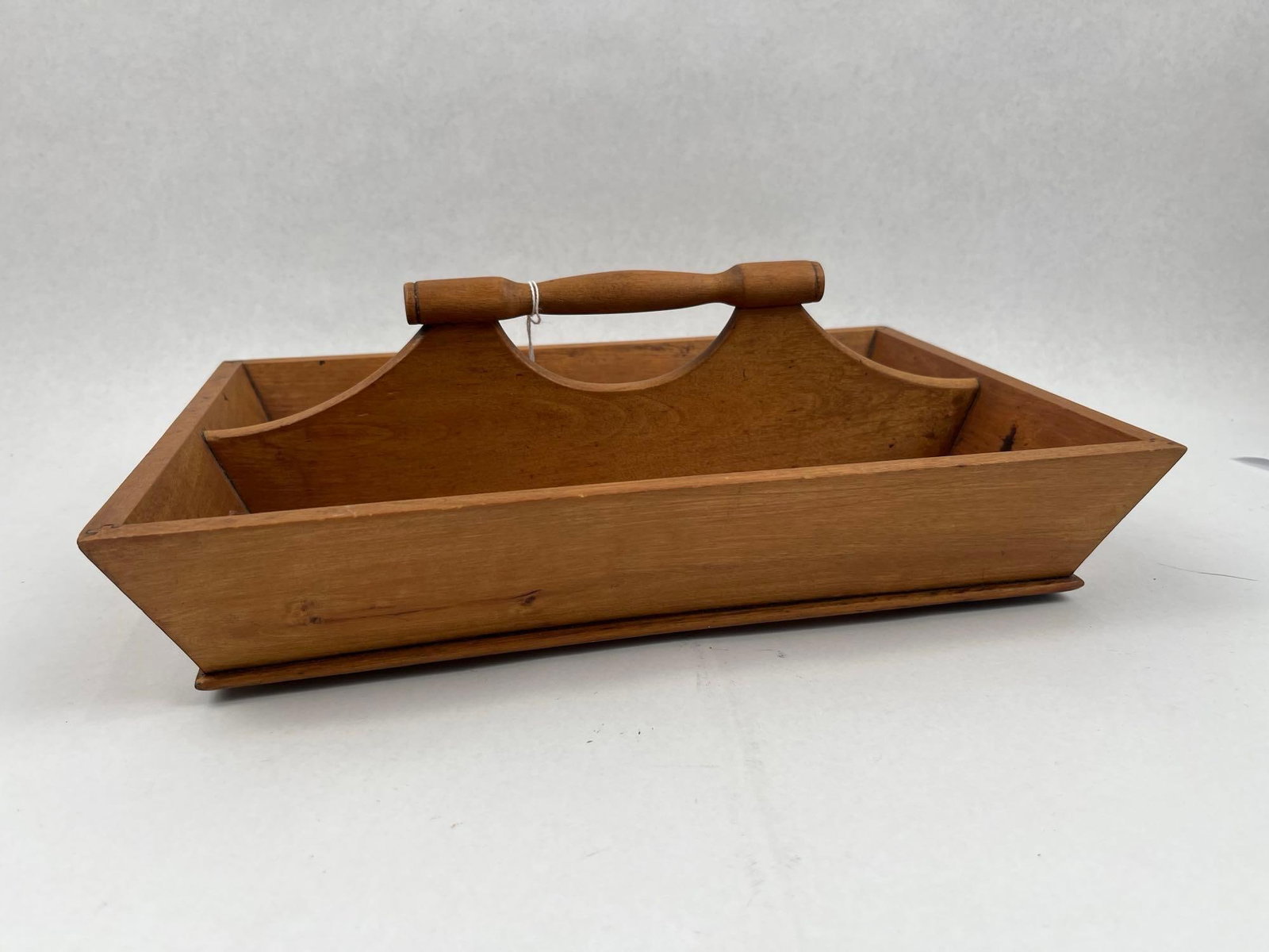 American Cross-Splined Cutlery Tray: This two-compartment wooden cutlery tray or tool caddy is constructed from stained wood, likely pine, with flared, slanted sides. A central vertical divider features a decoratively shaped profile and