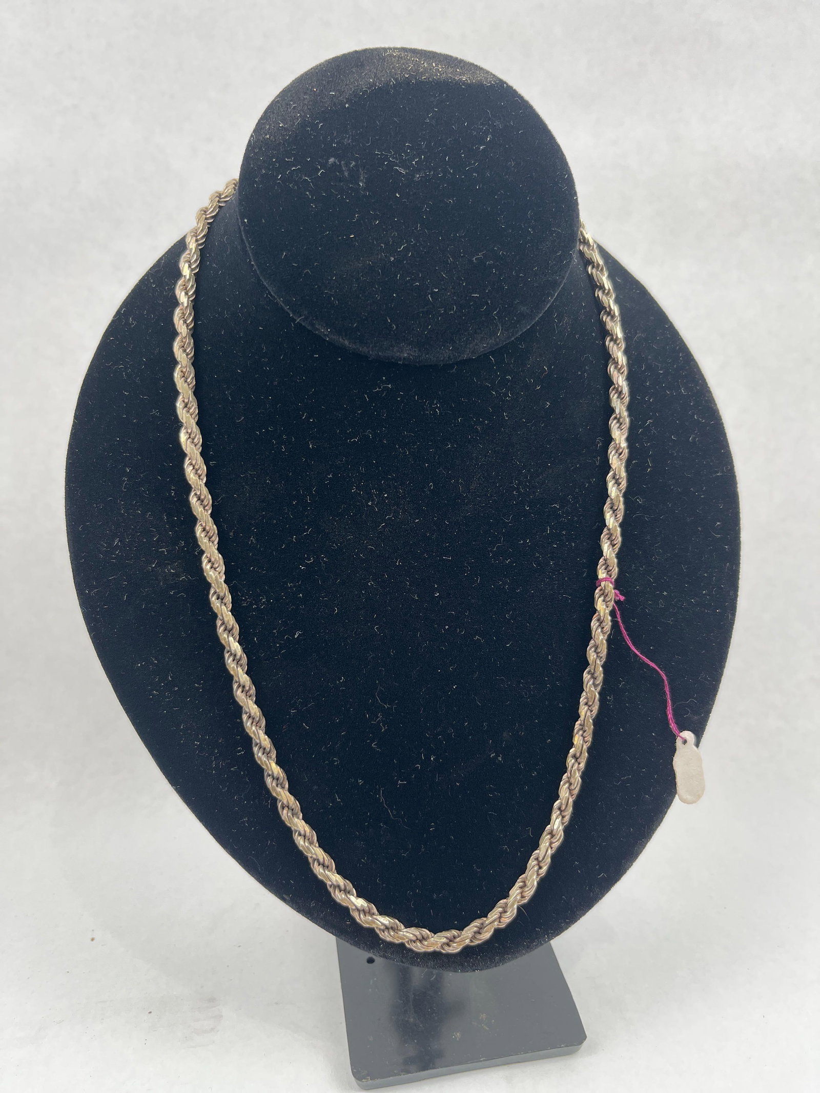 Gold-Tone Sterling Silver Rope Necklace: A rope chain necklace featuring a twisted link design with a gold-tone finish. The necklace is secured by a lobster claw clasp. An impressed mark is located on the inner trigger of the clasp, reading 