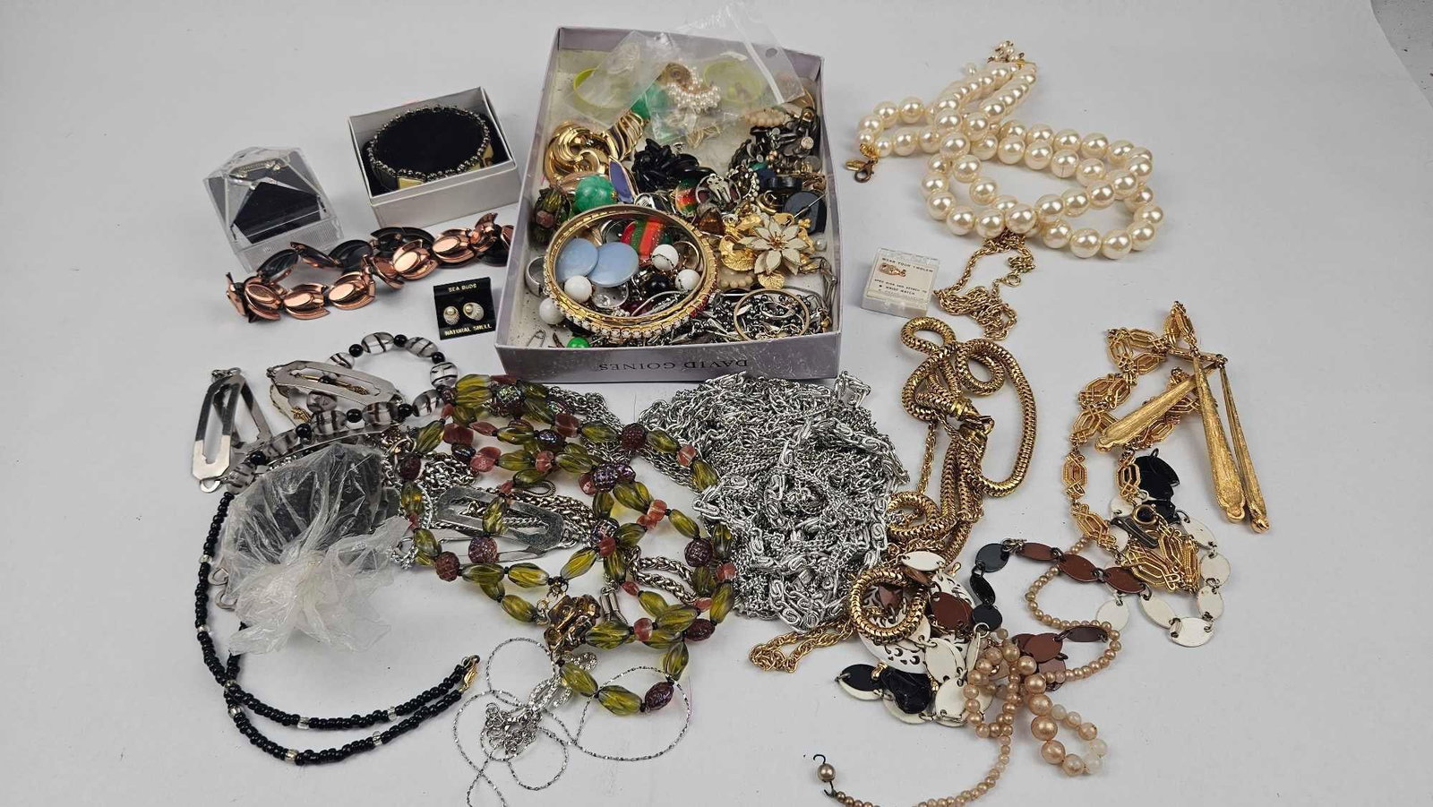 Costume Jewelry & Accessories: A collection of vintage and contemporary costume jewelry and accessories comprising necklaces, bracelets, earrings, brooches, and hair ornaments. The group features multiple strands of faux pearls wit