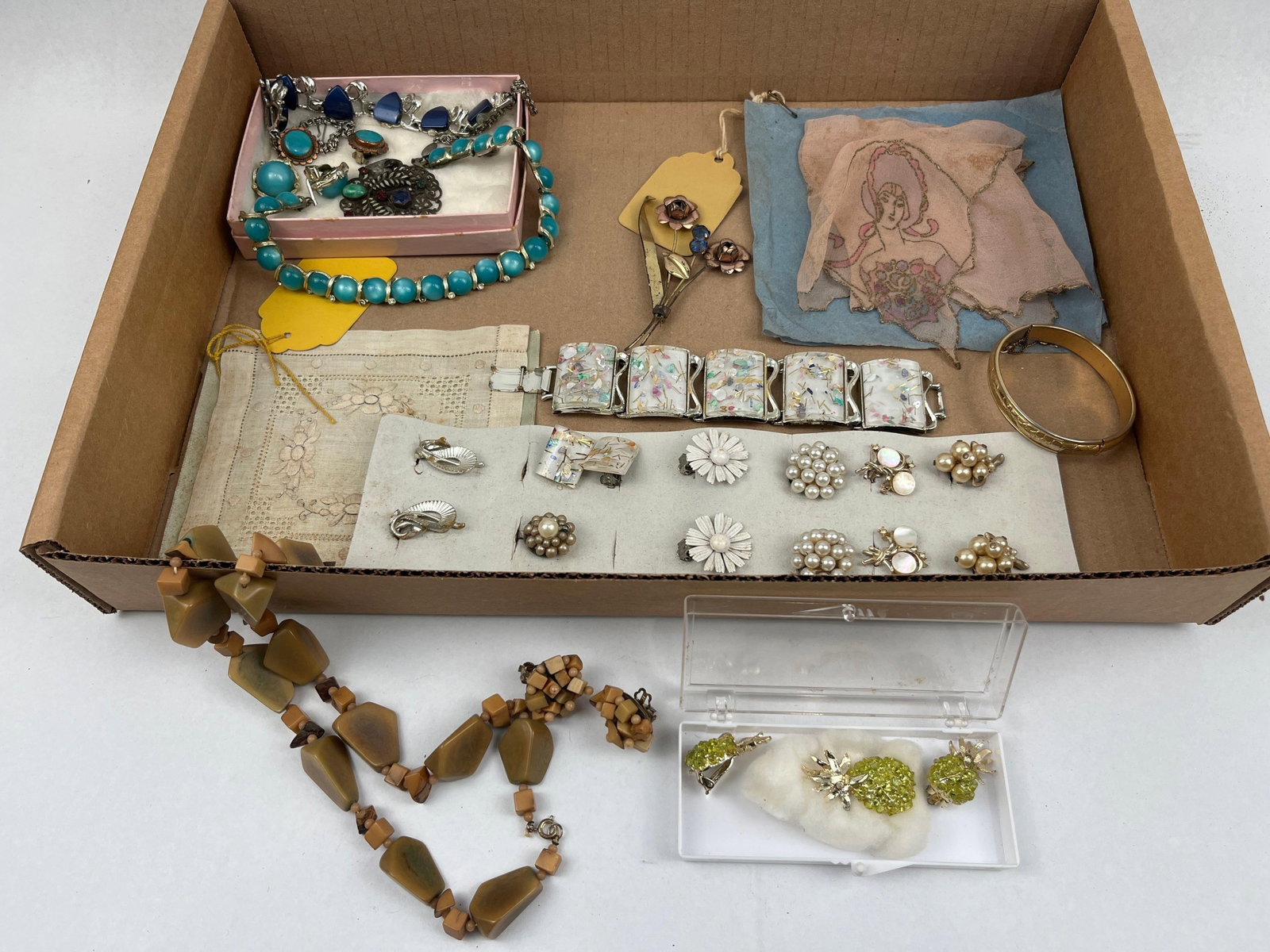 Costume Jewelry & Fashion Ephemera: This collection consists of several pieces of vintage costume jewelry and fashion accessories reflecting boho and mid-century aesthetics in mixed materials. A primary highlight is a suite of faceted g