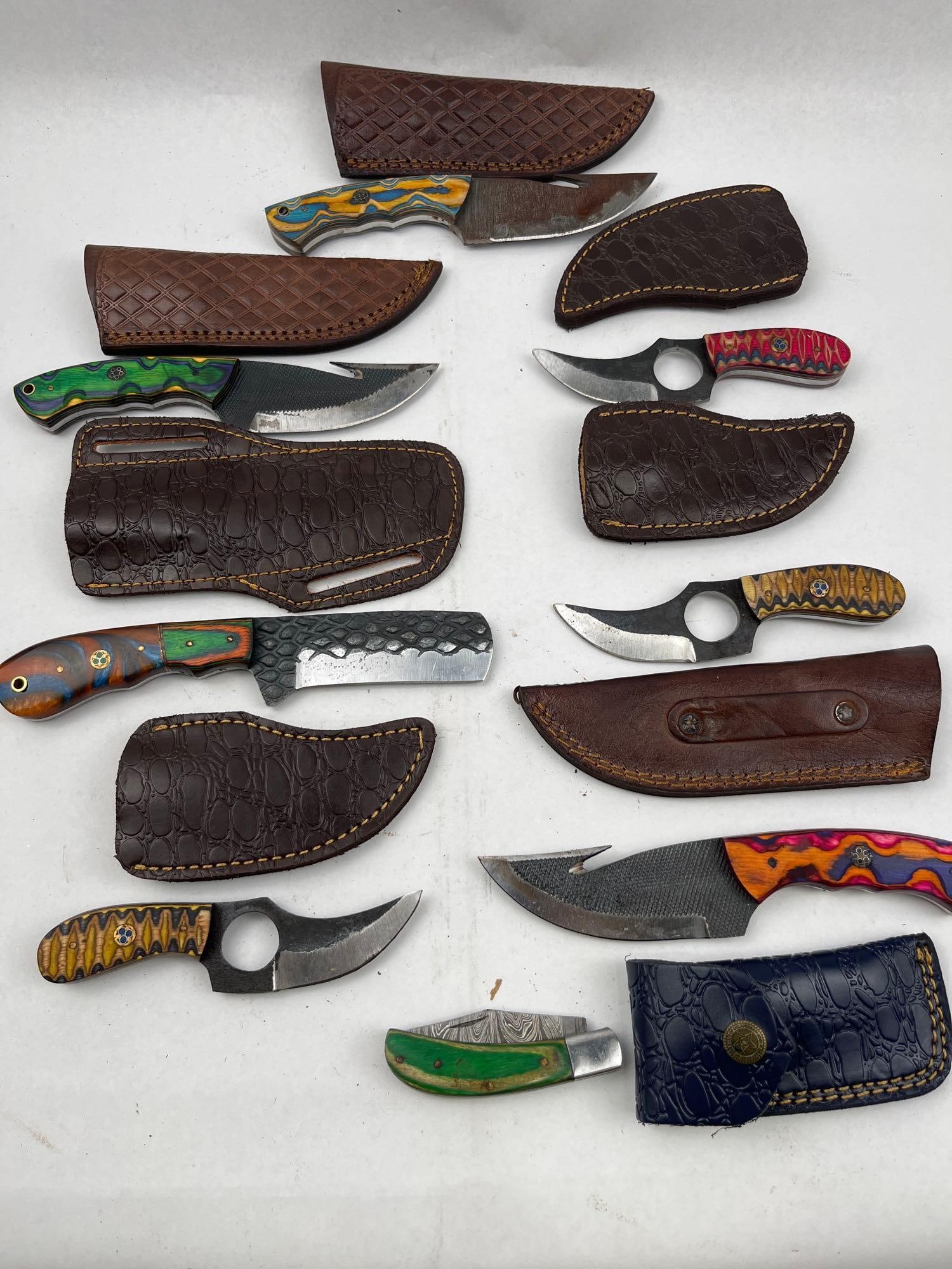 Custom Fixed & Folding Knives w/Sheaths: An assortment of handcrafted knives including various fixed-blade profiles and one folding knife. The collection features several gut-hook skinners, a cleaver-style blade with a hammered texture on th