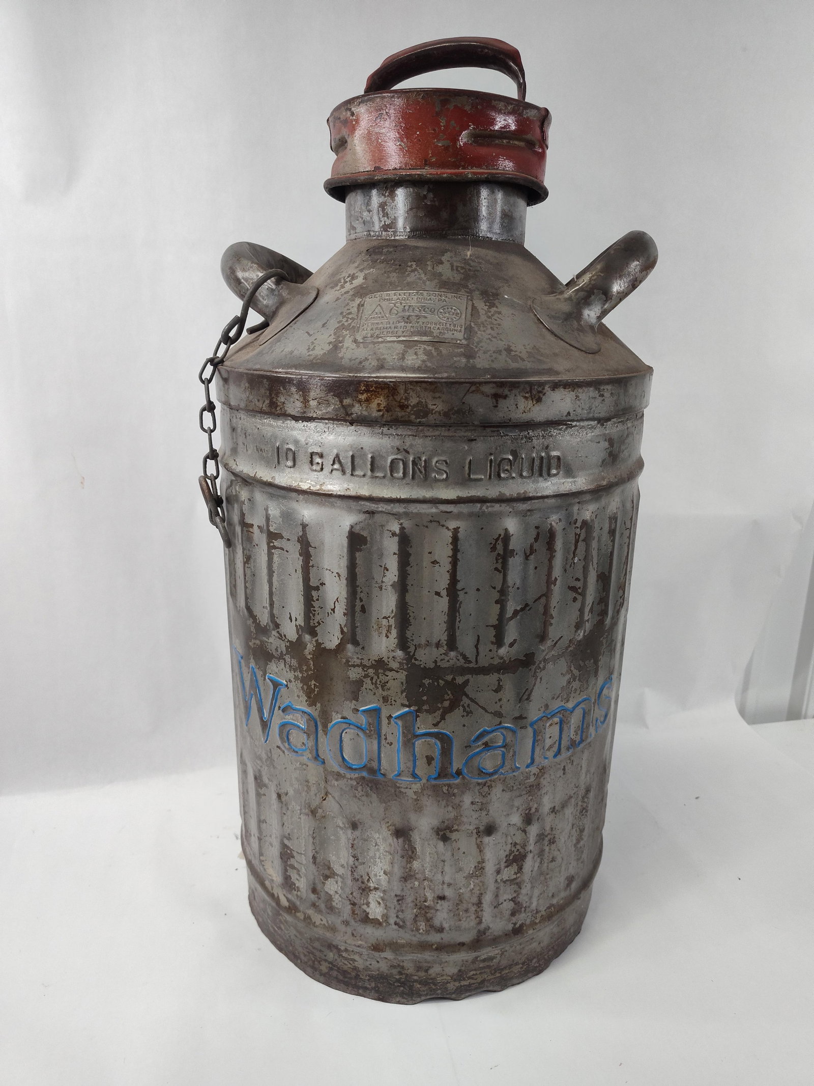 Ellis & Sons Wadhams 10 Gal. Steel Can: A galvanized steel liquid transport can designed for a capacity of ten gallons. The cylindrical vessel features a vertically corrugated body and is fitted with two stationary bail handles at the