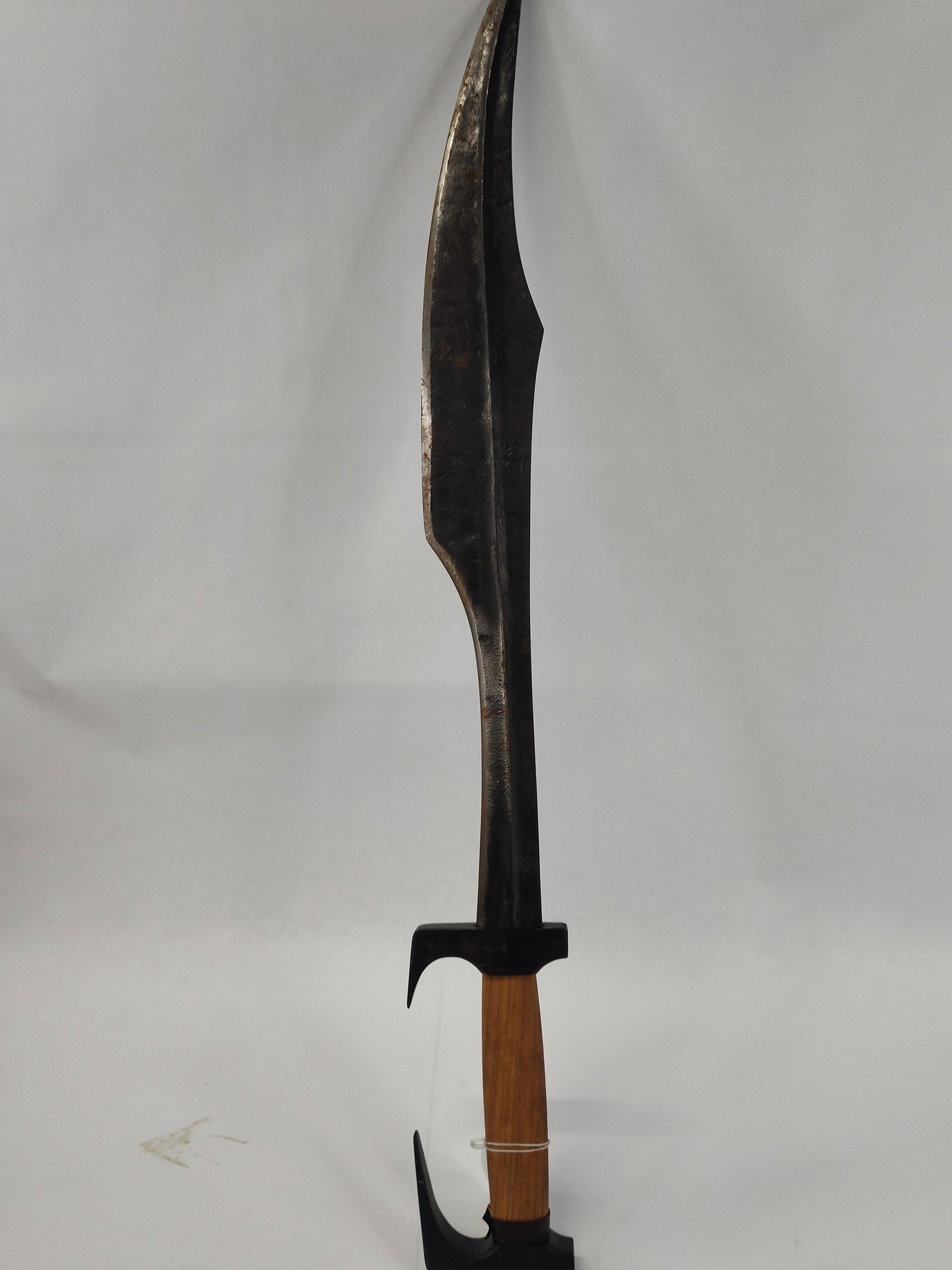 Hungarian Forged Steel Spartan Sword: A contemporary custom-made sword crafted in the style of a Spartan xiphos, featuring a forward-curving, single-edged blade with a wide belly and a prominent central ridge. The blade is constructed