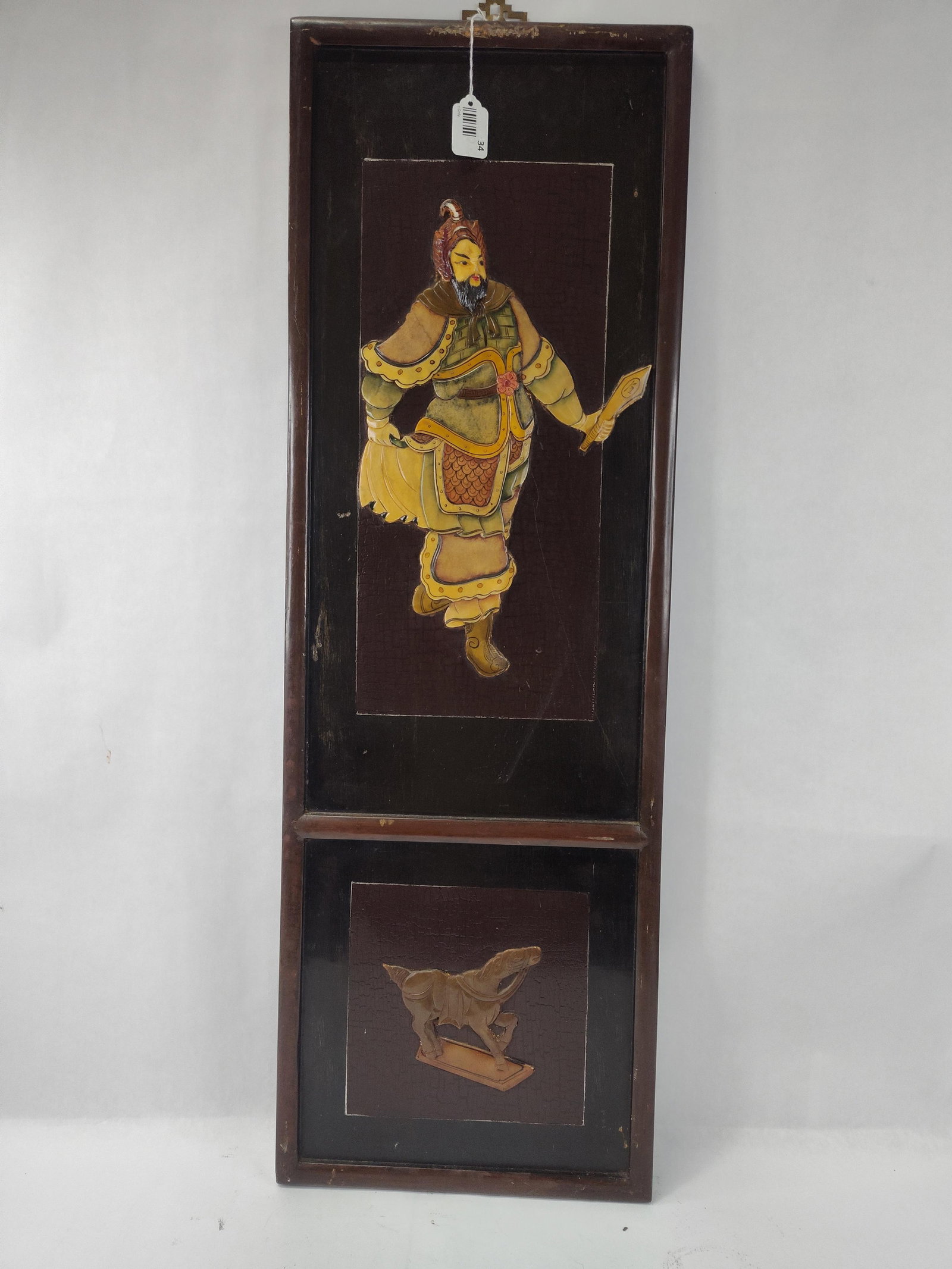 Chinese Black Lacquer Wood Wall Panel: A vertical Chinese wall panel constructed of black lacquered wood. The panel is divided into two framed sections featuring carved relief elements with polychrome paint. The larger upper section