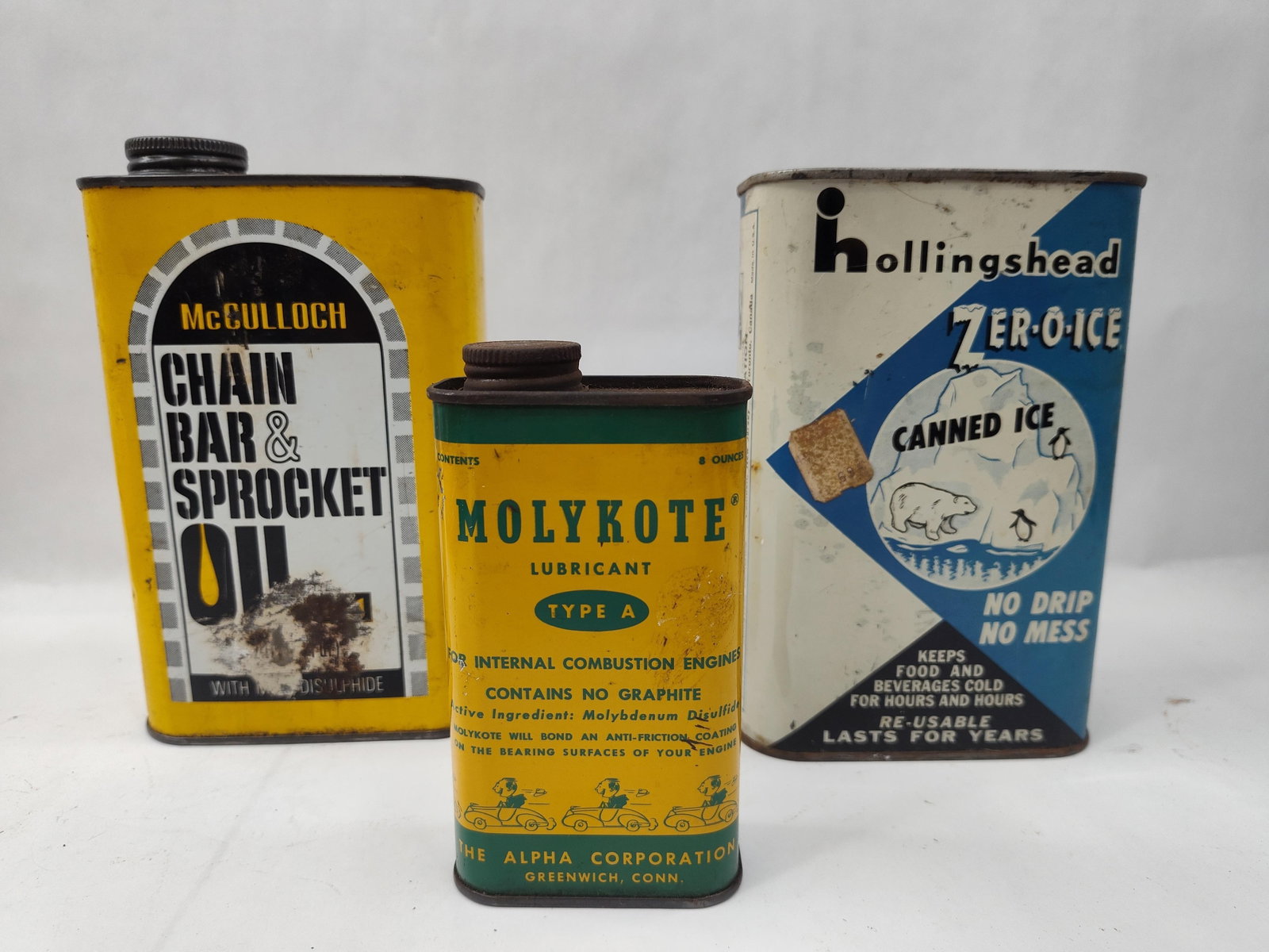 Set of 3 Advertising Tins: A group of three American advertising containers comprising industrial and household specialty products. The collection features a yellow lithographed tin for "McCULLOCH CHAIN, BAR & SPROCKET OIL" whi