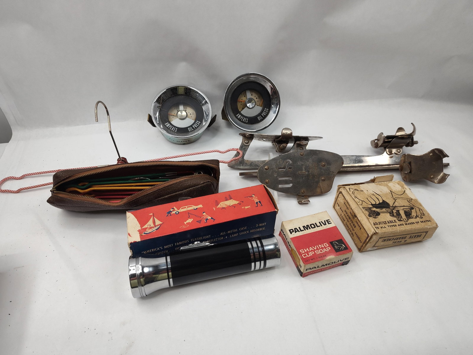 Americana Stewart-Warner Gauges: A collection of mid-century Americana featuring automotive accessories, tools, and personal care items. The lot includes two Stewart-Warner auxiliary gauge clusters, each with a chrome-plated