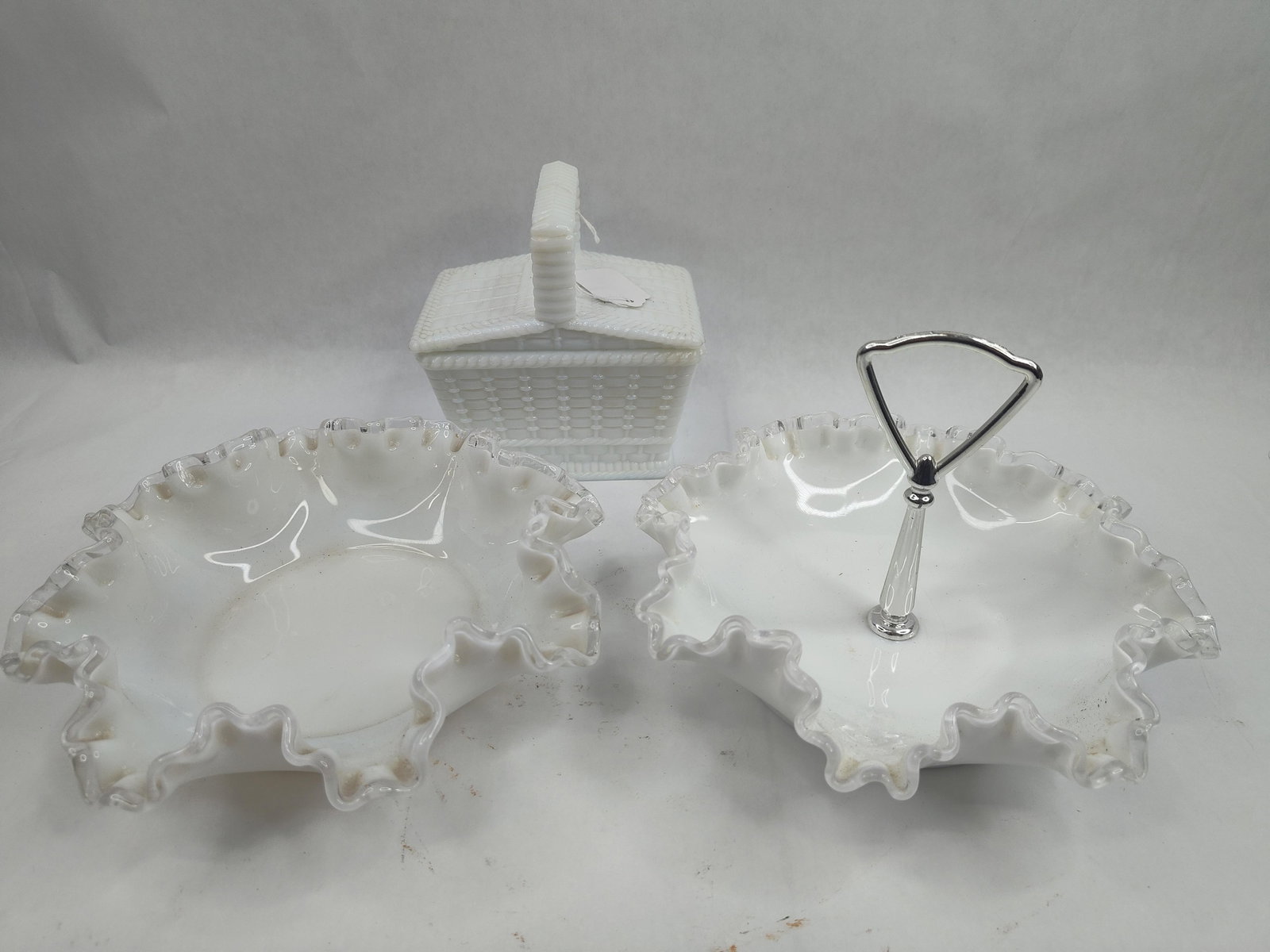 Trio Milk Glass Tableware w/ Ruffles: This lot consists of three pieces of white milk glass tableware characterized by a combination of opaque white bodies and translucent colorless glass detailing. Two pieces are shallow ruffled bowls