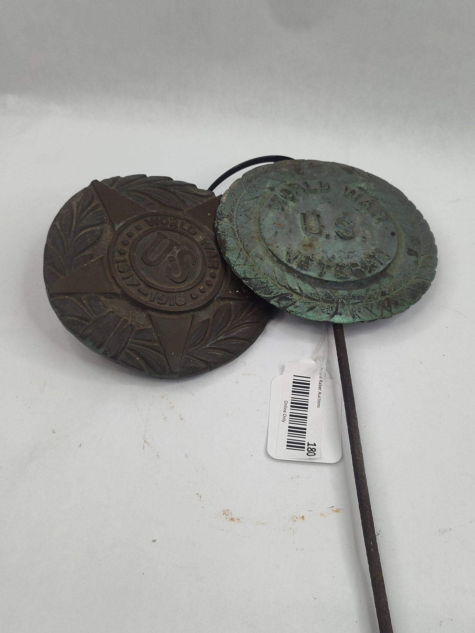 Pair Kenton Ohio Bronze WWI Markers: Two cast bronze World War I veteran grave markers. The first marker features a five-pointed star superimposed over a laurel wreath with a central medallion displaying the characters U.S. surrounded