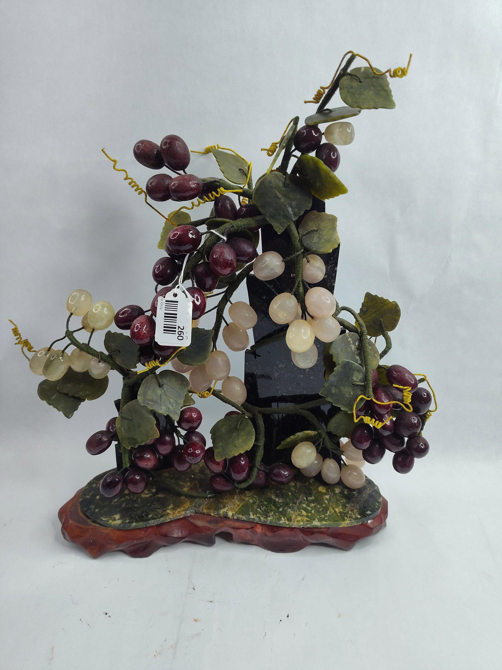 Chinese Carved Hardstone Grapes w/Base: A decorative carved hardstone sculpture depicting clusters of grapes in shades of translucent pale green and deep purple. The individual grapes are rounded and polished, attached to branches