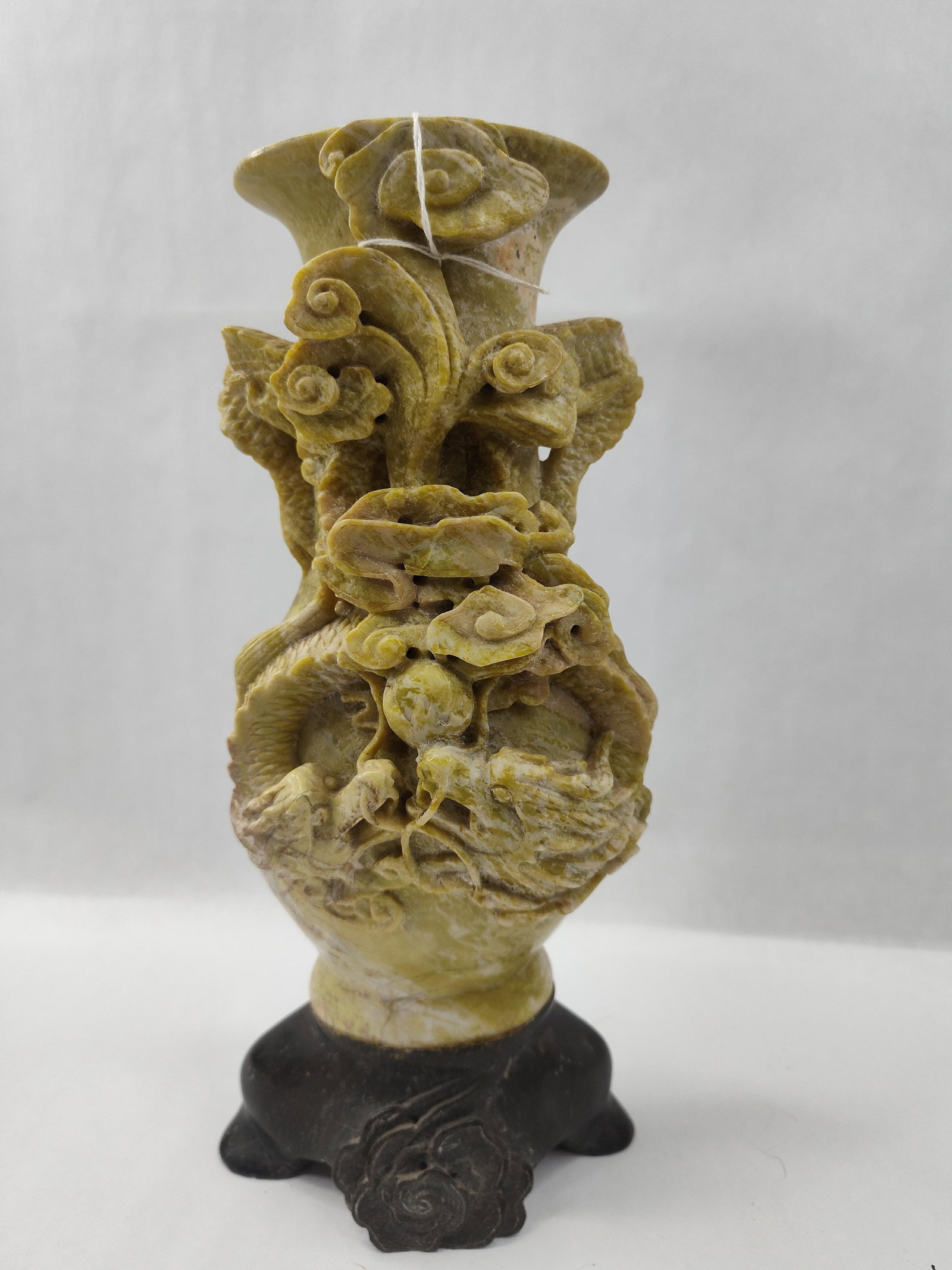 Carved Soapstone Dragon & Pearl Vase: A carved soapstone vase featuring a light yellowish-green and white mottled body. The vase is intricately decorated in high relief with a scaly dragon winding around the midsection. The dragon is