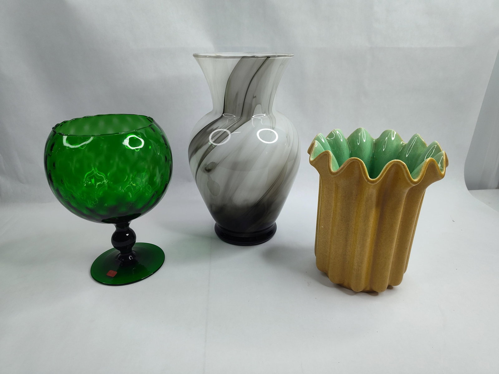 Set of 3 Mid-C. Red Wing & Glass Vases: This group consists of three distinct decorative objects. The first is an Italian green glass chalice featuring a molded honeycomb or thumbprint texture to the bowl. It is supported by a black glass p