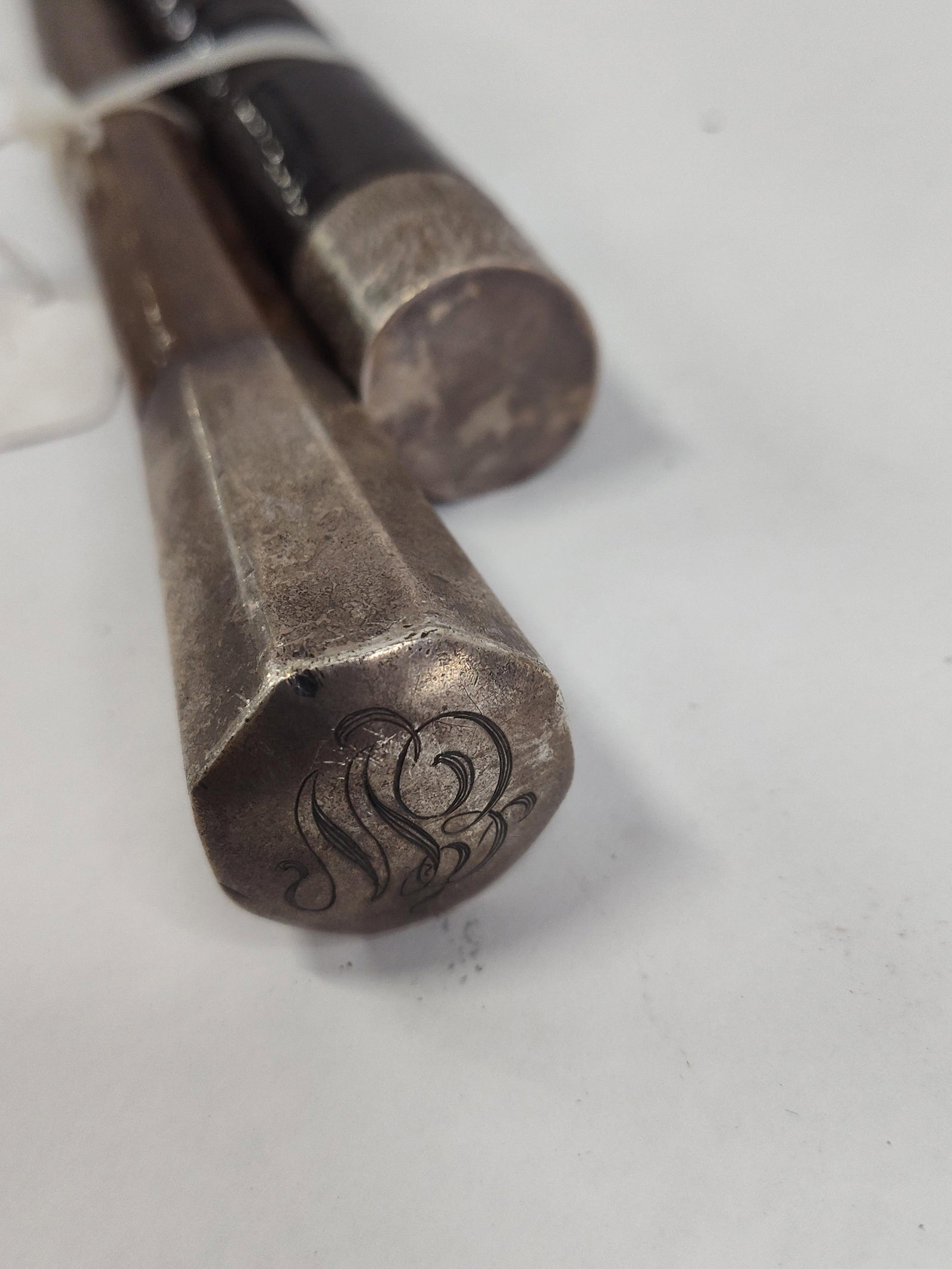 Pair Str. Silver Mounted Walking Canes: A pair of walking canes featuring varied wooden shafts and silver mounts. One cane is constructed with a medium-brown, smooth-finished wooden shaft of octagonal cross-section. It is capped with a