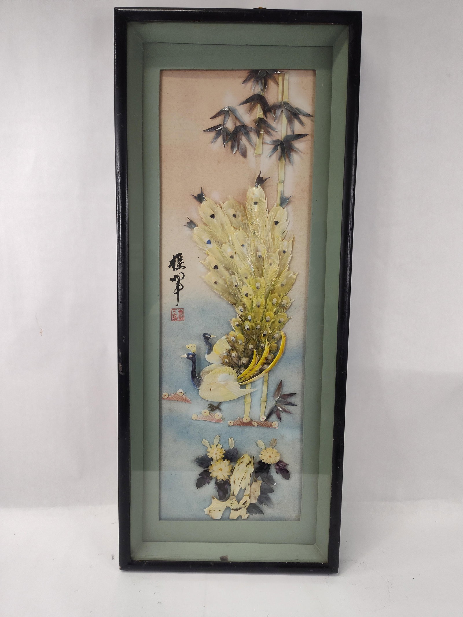 Chinese Shell & Bamboo Relief Shadowbox: A Chinese relief shadowbox artwork featuring two peacocks, bamboo stalks, and floral elements, intricately crafted from carved and layered shell. The shell components are arranged to create a