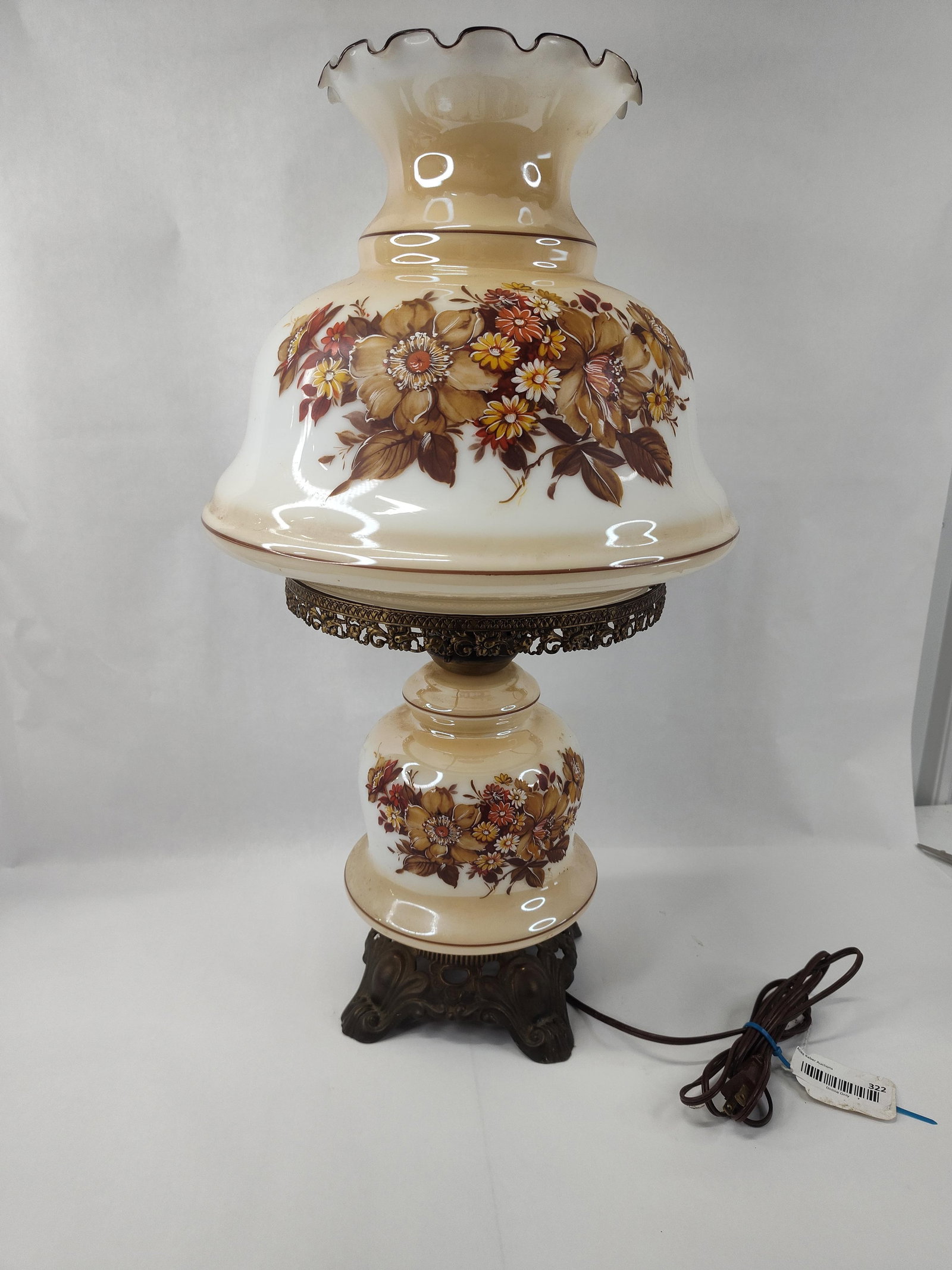Floral Milk Glass Hurricane Lamp: This electric parlor lamp is designed in the Gone with the Wind hurricane style, featuring a two-part milk glass body with a cream-to-white gradient finish. Both the large globular shade and the