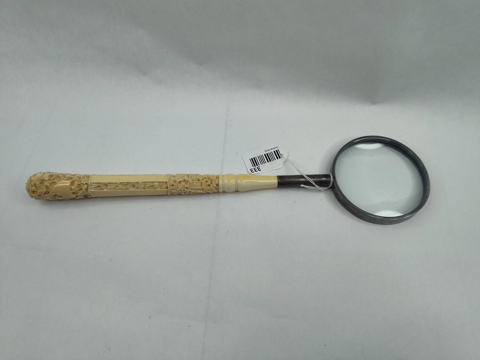 Bone Handle & Silver Mounts Magnifier: This magnifying glass features a three-section handle constructed from carved bone. The handle is composed of a floral terminal carved in high relief, a central octagonal shaft with recessed foliate