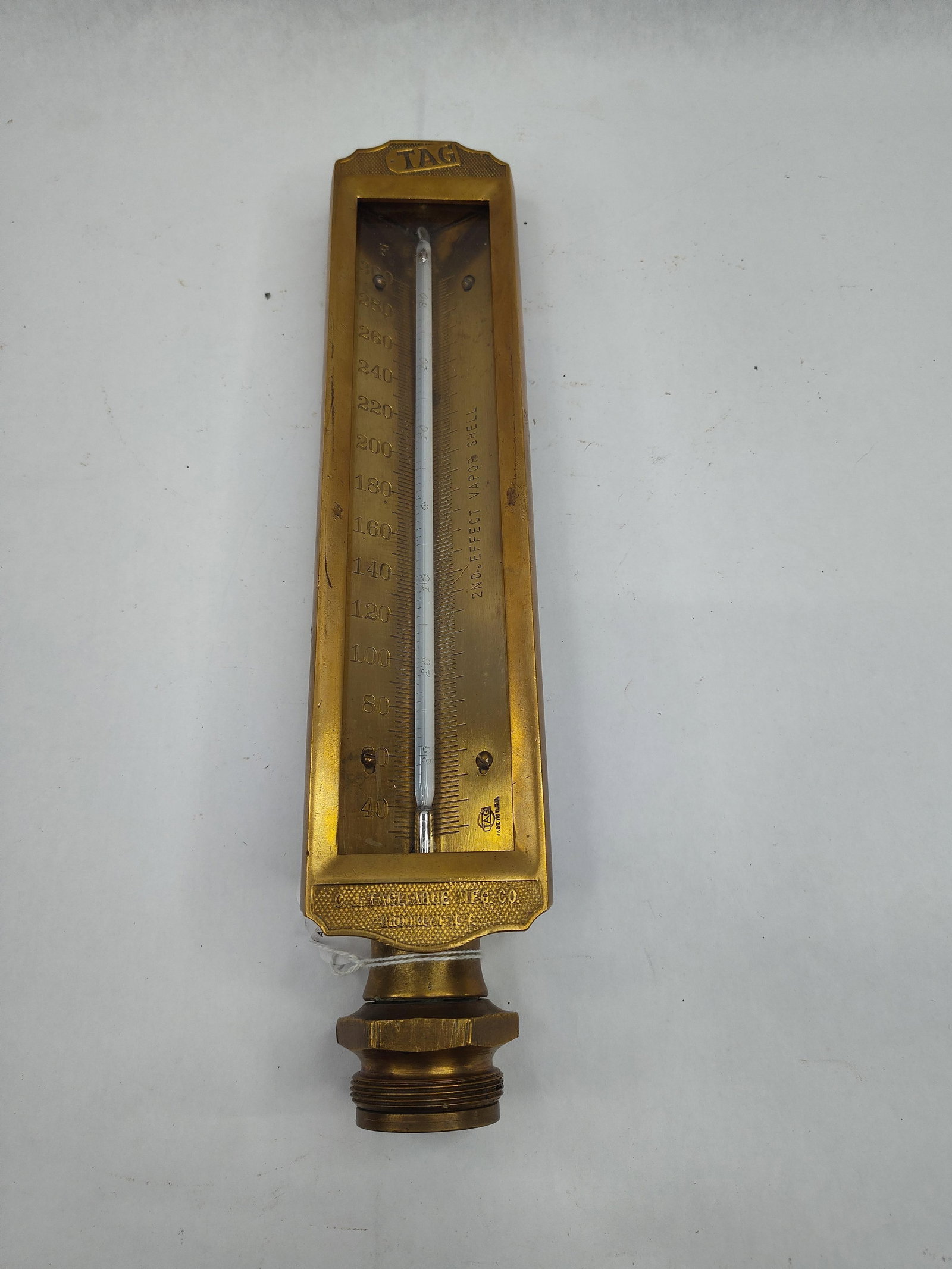 Tagliabue Brass Vapor Thermometer: This industrial thermometer is constructed with a heavy V-shaped brass housing and a threaded mounting base. Manufactured in the United States, the instrument was designed for a specific technical