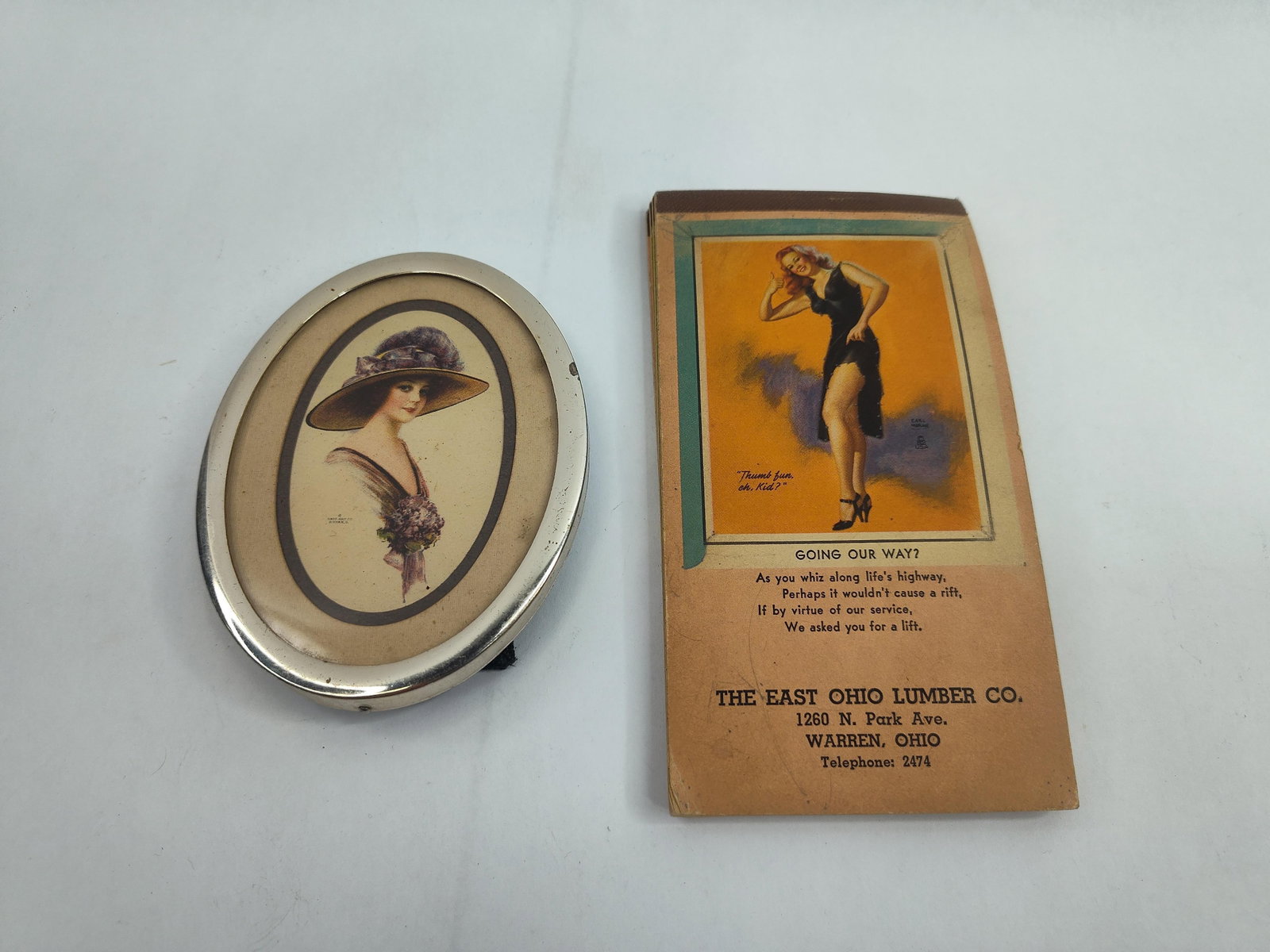 East Ohio Lumber Memo Books & Mirror: A collection of mid-century advertising ephemera comprising an oval pocket mirror and several promotional memo books issued by The East Ohio Lumber Co. The pocket mirror features a metal rim and a