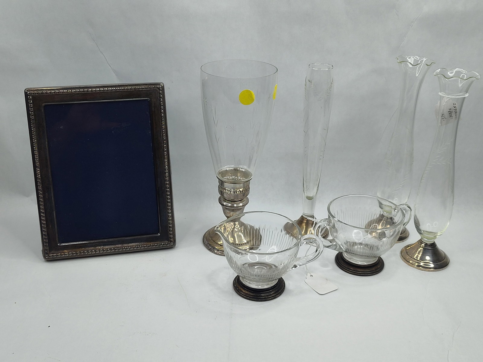 Str. Mounted Glass & Picture Frame: A collection of sterling silver mounted glassware and a picture frame, primarily 20th-century American manufacture. The group includes several glass bud vases and a large center vase featuring etched