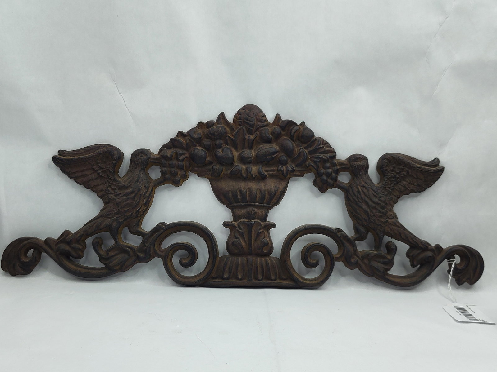 Cast Iron Pediment w/ Birds & Fruit: A cast iron architectural pediment or wall hanging, hollow-cast in relief. The central motif features a classical gadrooned compote or urn overflowing with a variety of fruits, including a central pin