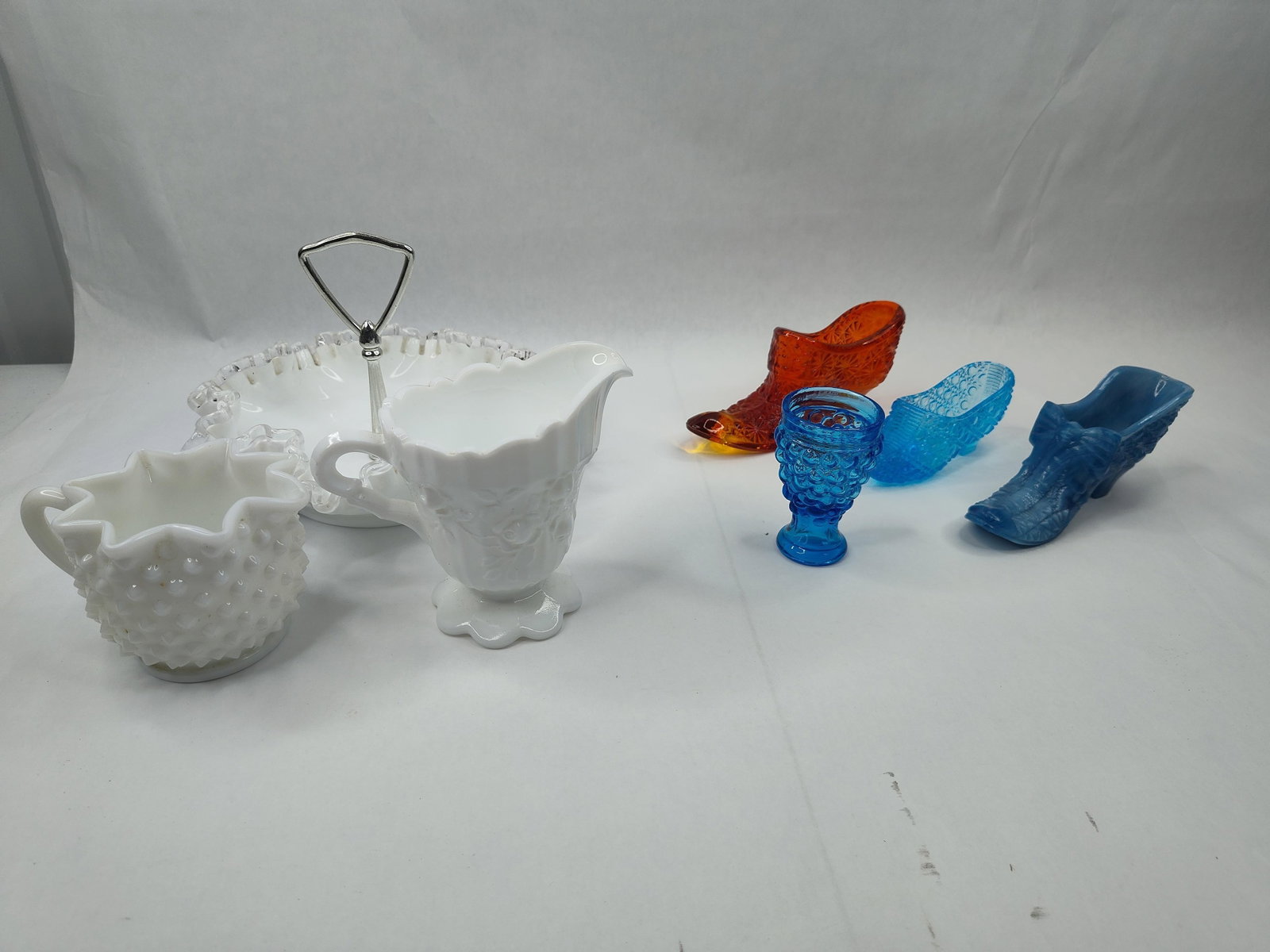 Set American Pressed & Milk Glass Items: An assortment of mid-century American pressed glassware in various colors and styles. The collection features several pieces of opaque white milk glass including a creamer with a hobnail pattern and