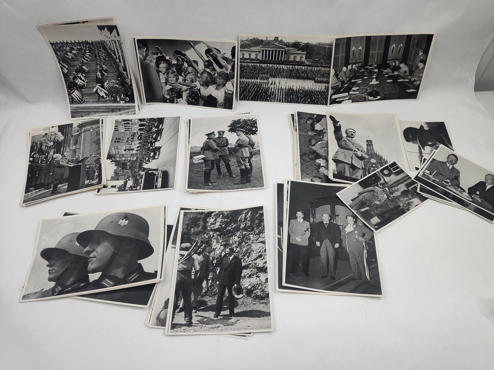 German Third Reich Photos & Postcards: An assortment of black-and-white historical photographs and postcards depicting subjects from the German Third Reich era. The collection includes a mix of candid and staged imagery featuring Adolf